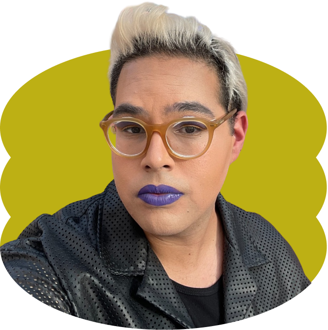 Dozandri C. Mendoza looking at the camera, with glasses, purple lipstick, and windswept blonde hair, wearing a black jacket and shirt, placed over a scalloped yellow oval shape.