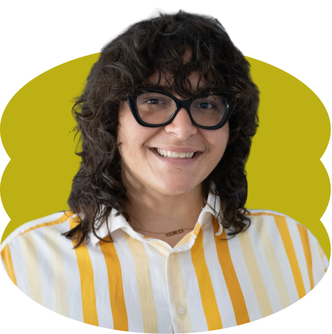Valeria Tizol, smiling with curly brown hair, wearing black glasses, a striped yellow and white shirt, placed over a scalloped yellow oval shape.