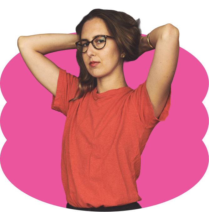Carina del Valle wearing glasses and brown hair, wearing a red t-shirt, with her arms raised and hands behind her head, placed over a scalloped hot pink oval shape.