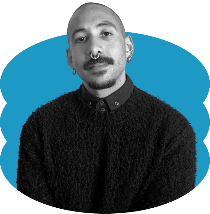 Pedro J. Rolón in a black and white portrair with a buzzcut, mustache and septum piercing, wearing a textured dark sweater and collared shirt, placed over a scalloped blue oval shape.