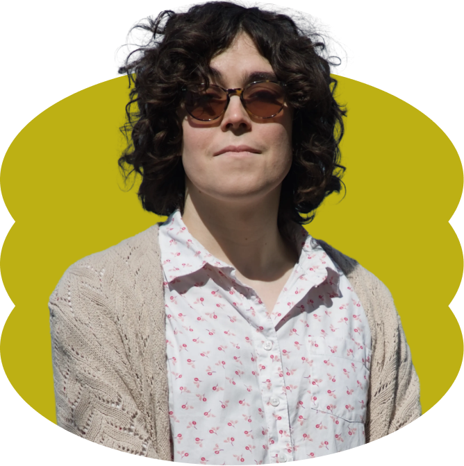 Sofia Rivera with curly dark hair wearing sunglasses, a white button-up shirt with a pink floral pattern, and a beige cardigan, placed over a scalloped yellow oval shape.