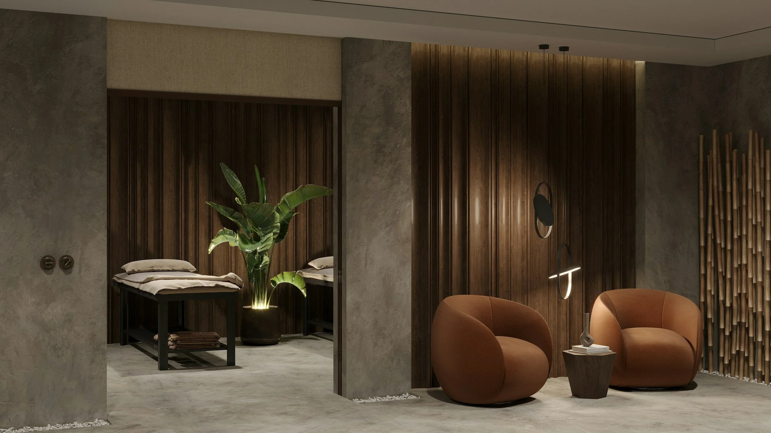 Modern hotel room or lounge area with two brown armchairs, a side table with a lamp, a large potted plant, and a bed area with folded towels, against a backdrop of wood-paneled walls and textured concrete surfaces.