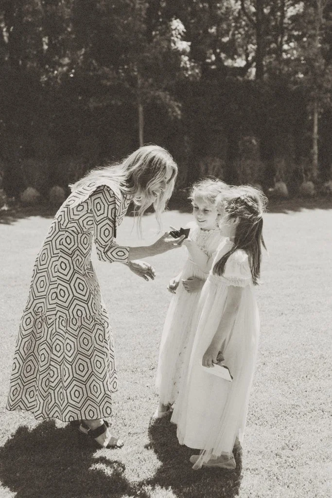 Wedding childcare provider interacting with children during an outdoor wedding event