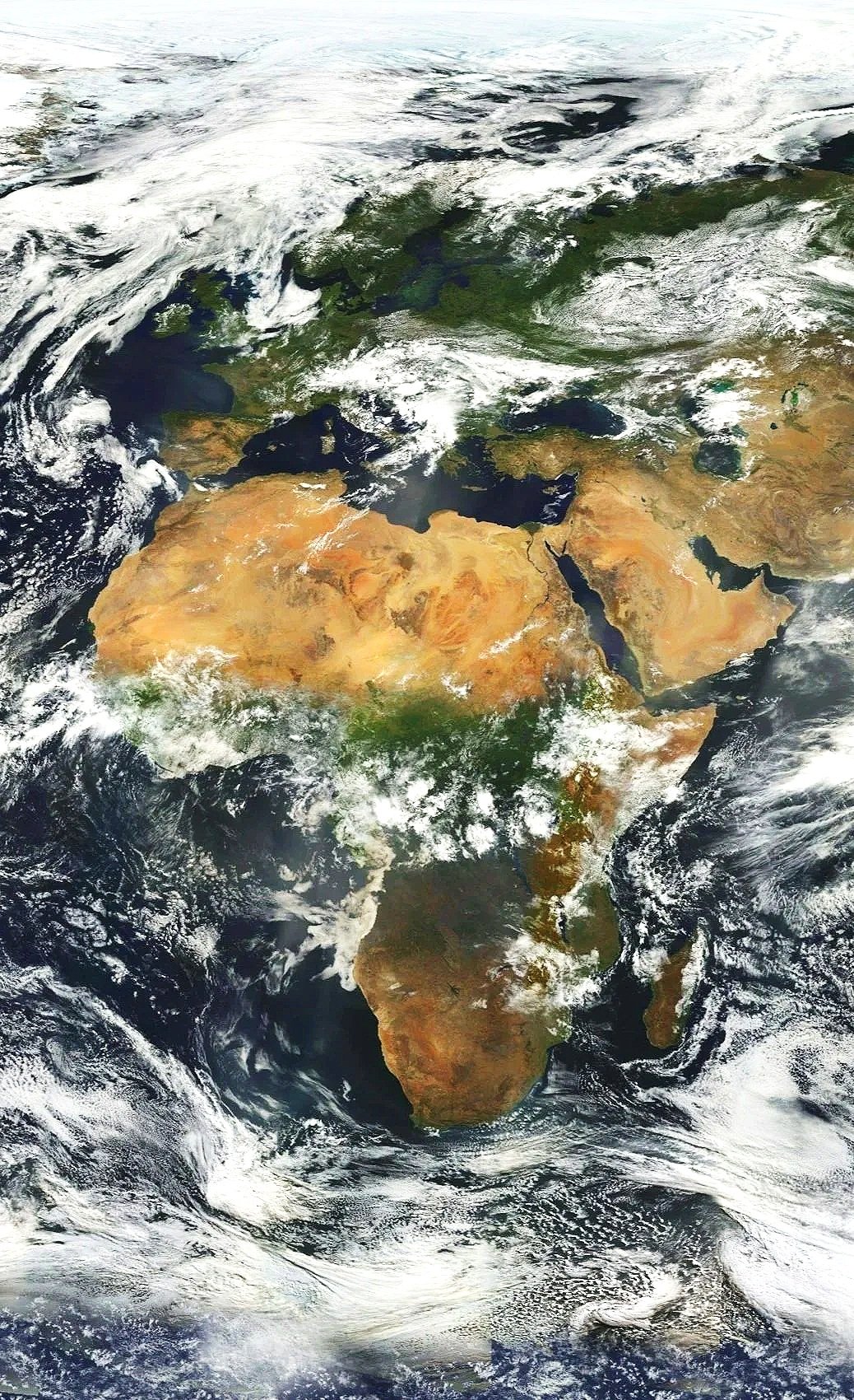 Satellite view of Africa, Europe, and parts of Asia from space, showing land, water bodies, and cloud cover.