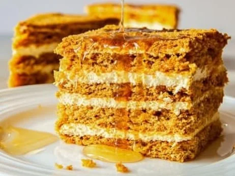 Honey cake layers, cream filling, and honey drizzle.