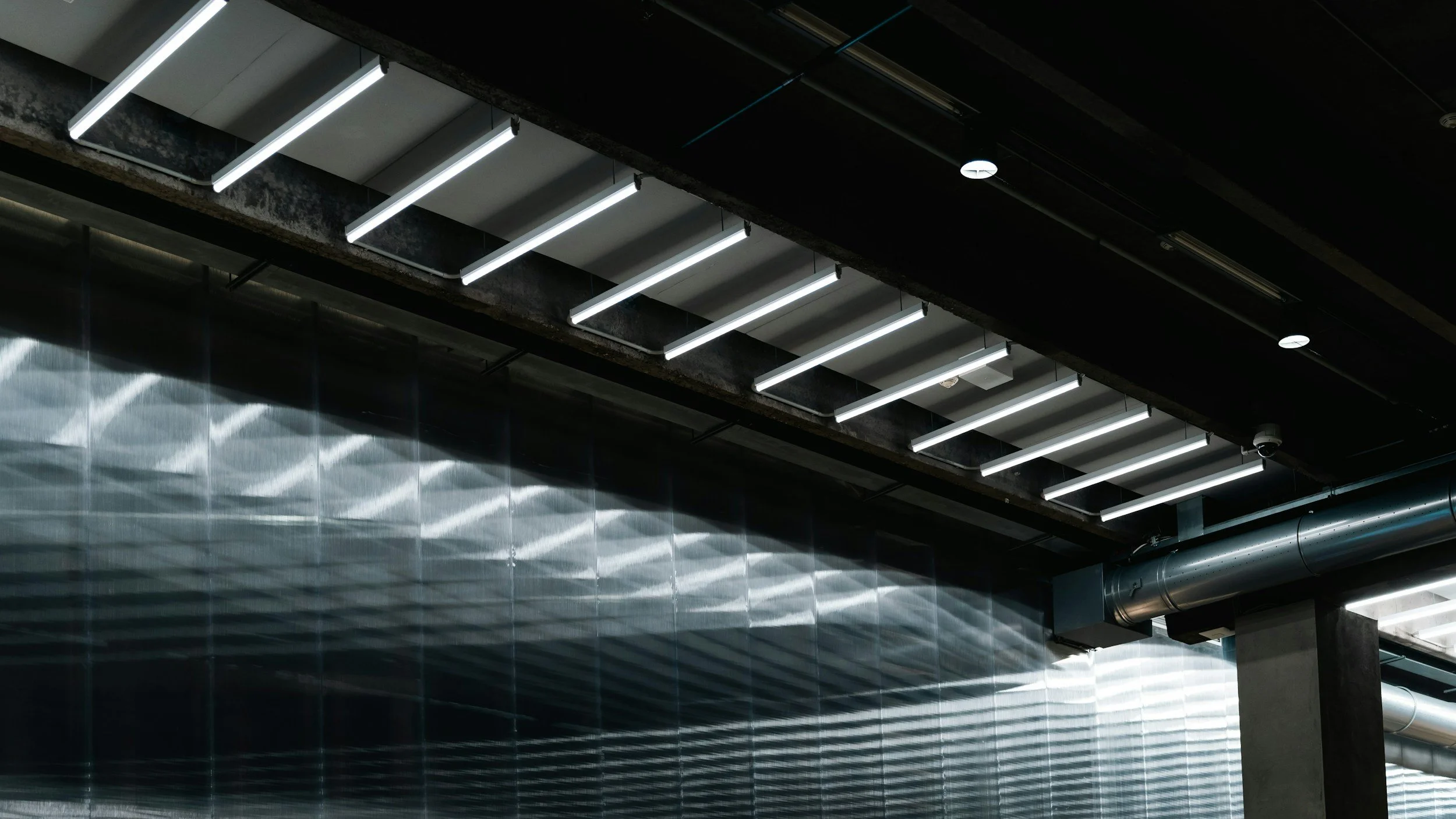 Before and after commercial LED retrofit in an Edmonton warehouse by Armada Electrical