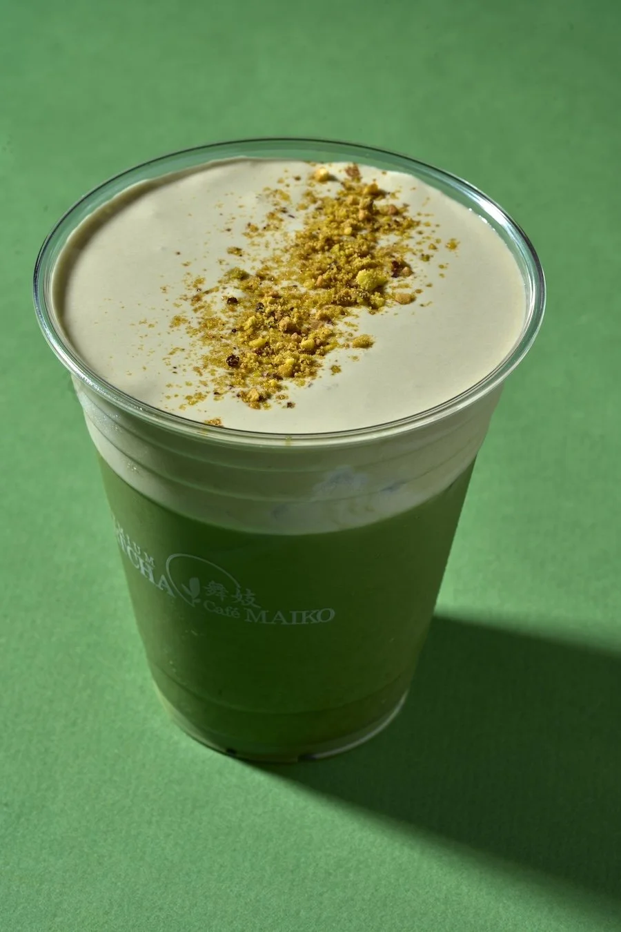 Matcha cafe maiko pistacho matcha latte on a green background