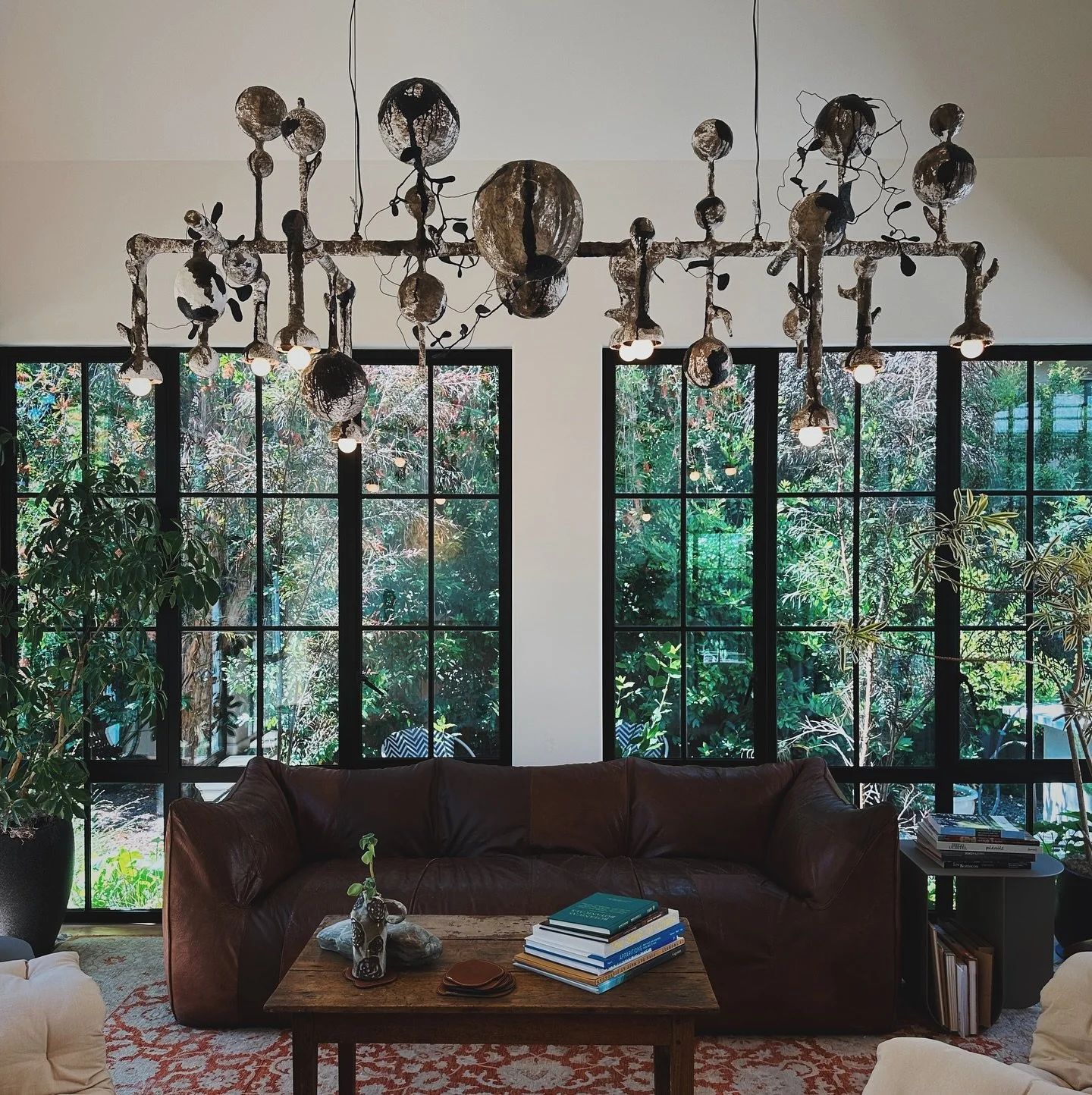 Nocturnal Symphony I
A 7-foot chandelier sculpture made of welded steel, layered by hand with plaster and painted in oil. Wire armatures branch outward, wrapped in blackened leaves like vines. Each element is shaped to evoke the rhythm of tree shadow