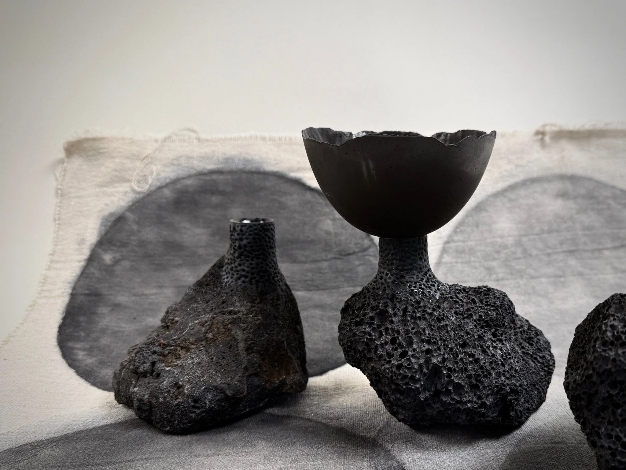 Volcanic Candlestick by Kept LA with charcoal Little Cup insert  on painted table linen, showing product pairing and scale relationship