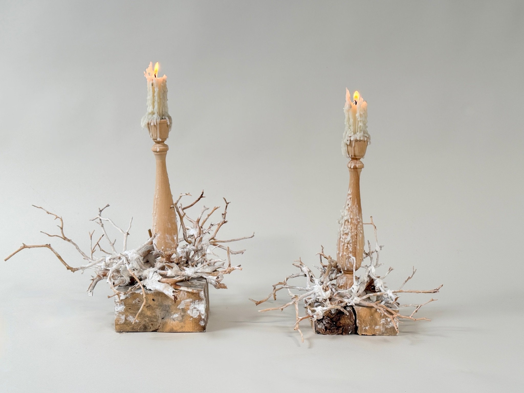 Pair of Woven Manzanita Candlesticks by Kept LA — turned wood  forms on raw wood block bases wrapped in plaster-dipped preserved  manzanita branches, shown with lit taper candles and wax drip patina