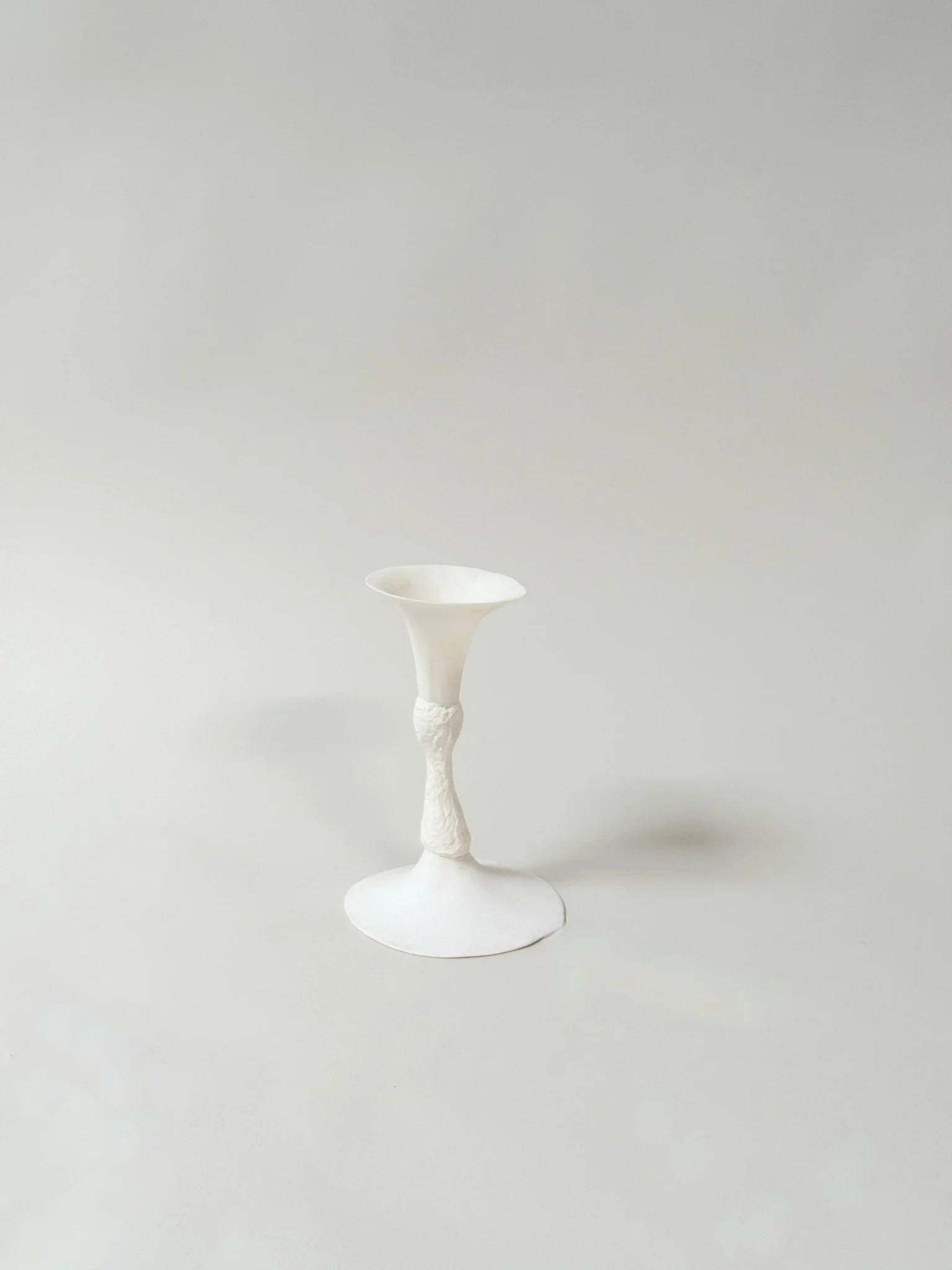 Vessel by Kept LA showing  single-cup form — cup holds water for a single stem or  taper candle, hand-cast mixed media construction each unique