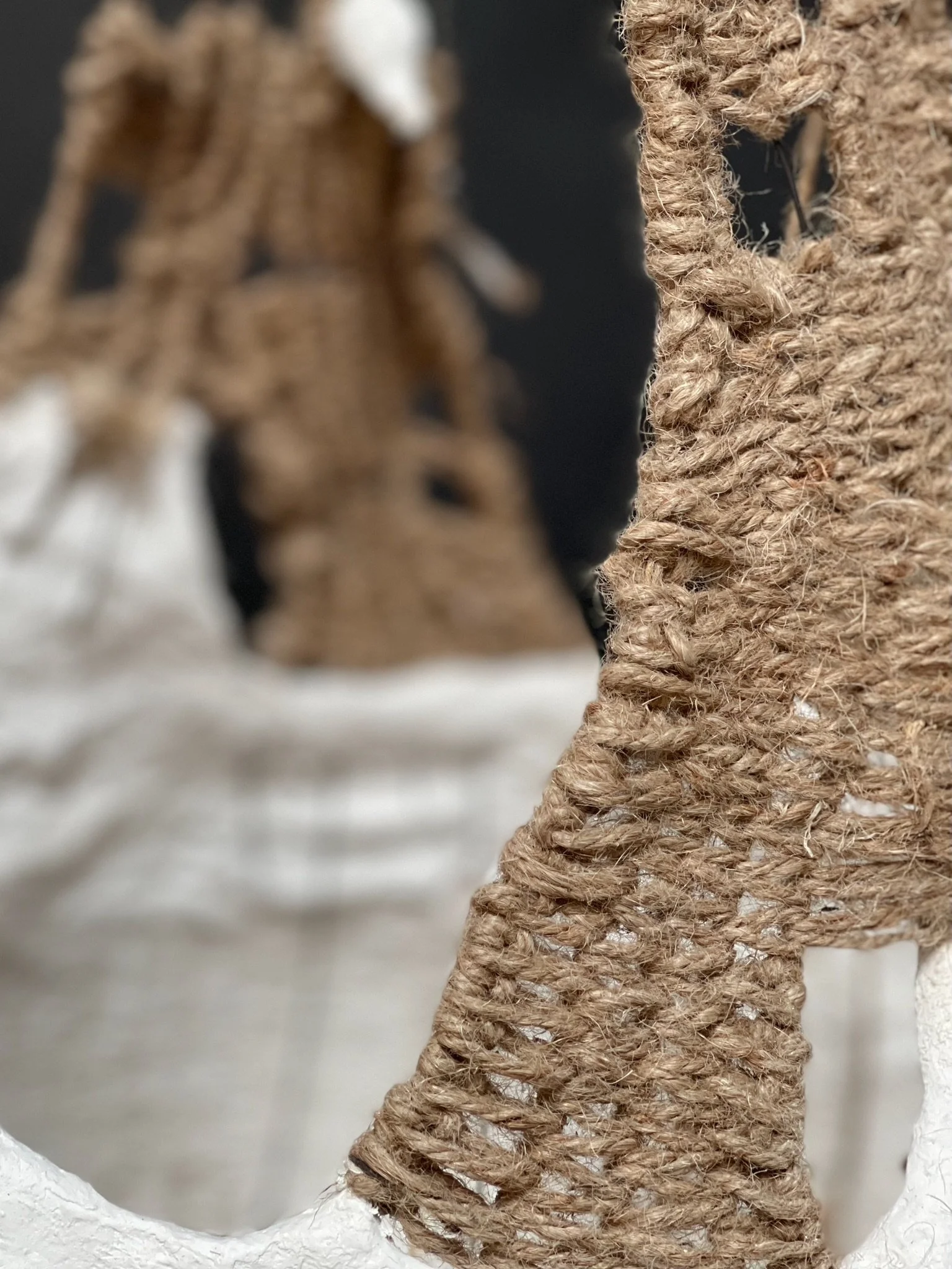 Detail of mixed fiber construction on Weave and Plaster Basket  by Kept LA — jute rope, linen, and wire armature wrapped and  knotted by hand