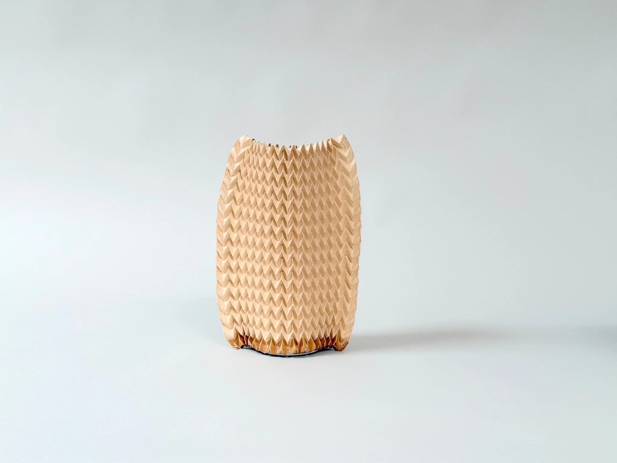 Cylinder Pleated Paper Vase Sleeve by Kept LA  in natural tan tone, clean product shot showing upright form  and pleated texture