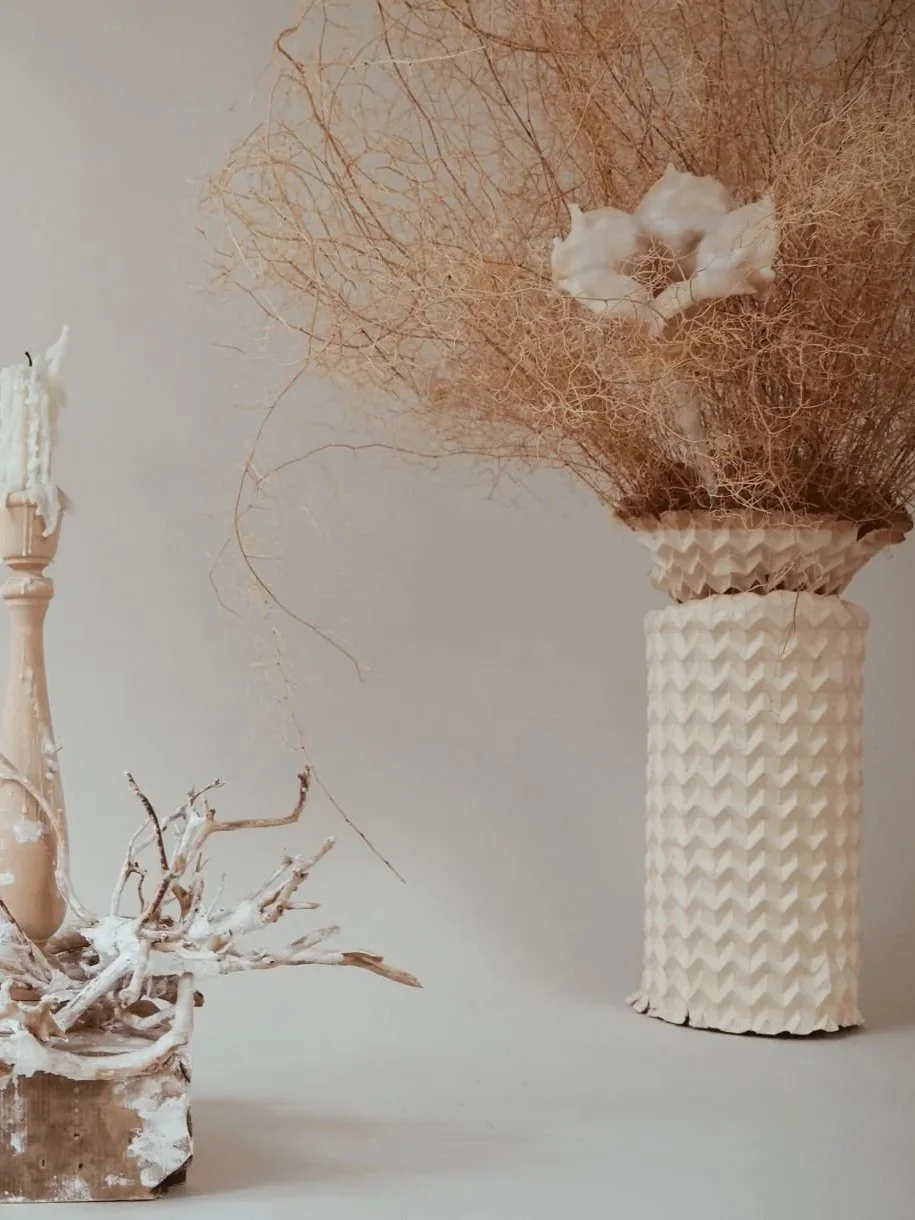 Tall Pleated Paper Vase Sleeve by Kept LA styled with dried  pampas grass and botanicals in an interior setting showing medium  cylinder size in situ