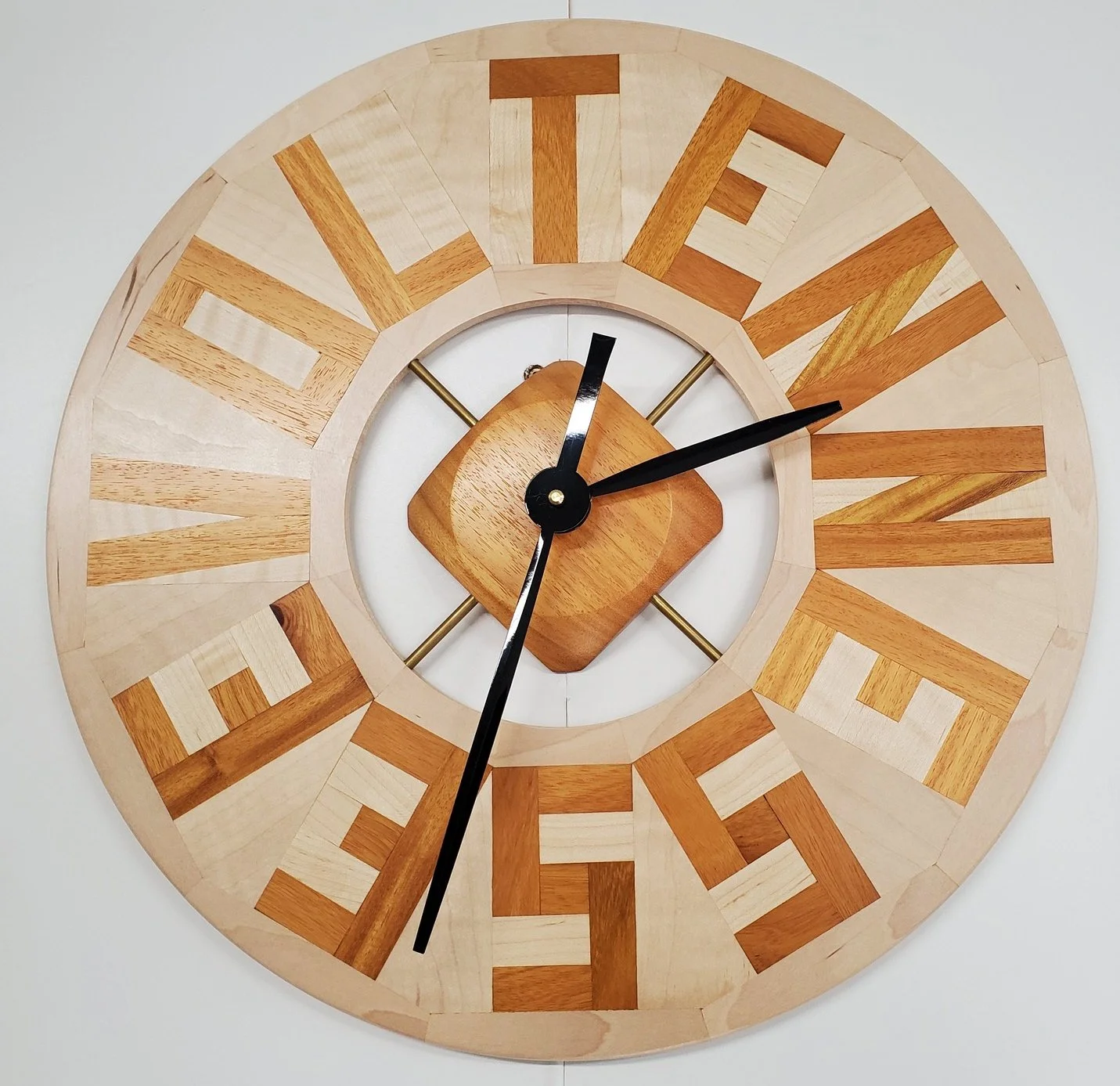 The wood is osage orange and maple, and I used brass rods to mount the clock mechanism. Around 17" diameter.
