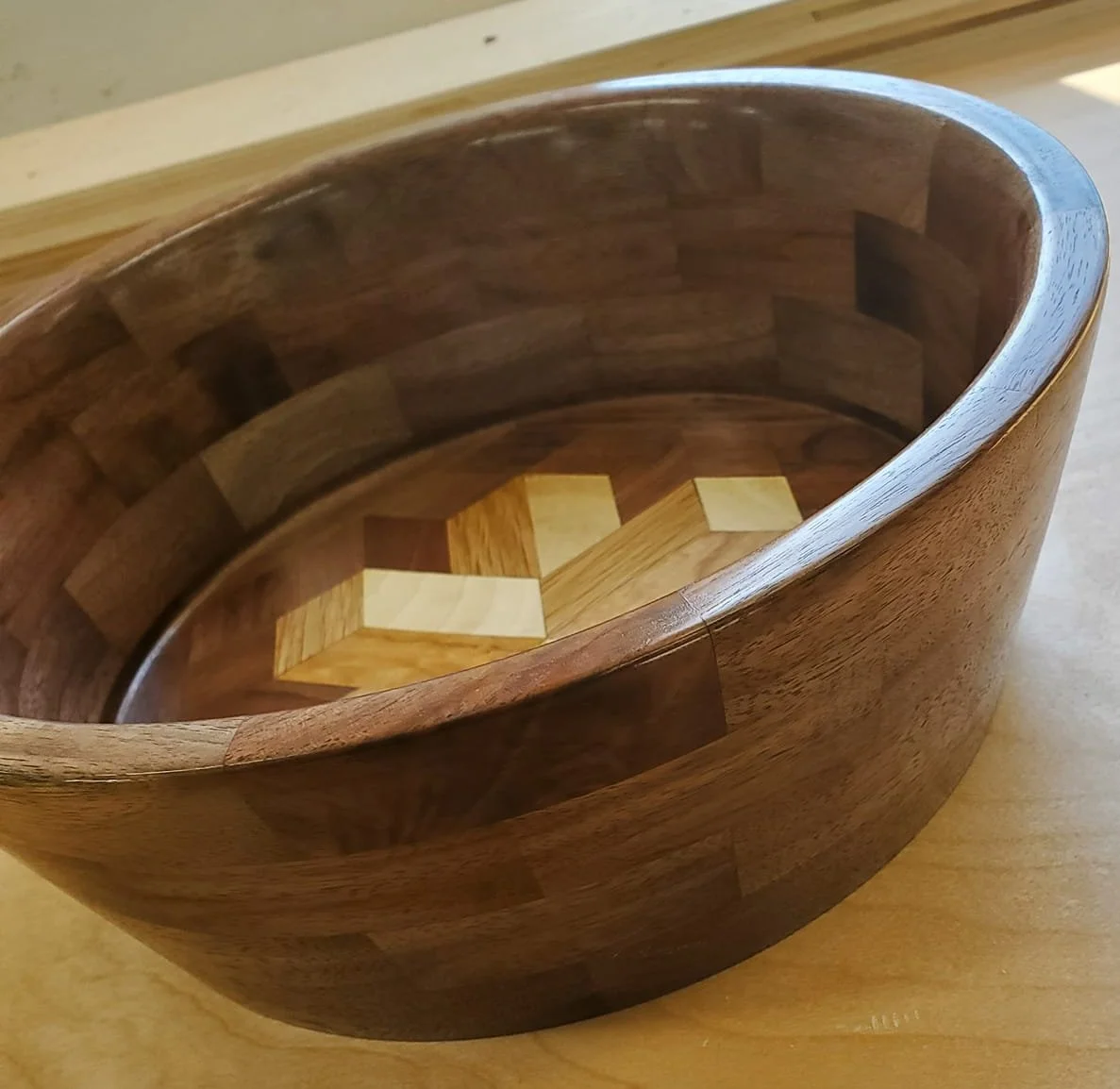 The bowl is made from walnut and the design is maple, cherry, and oak. Pretty