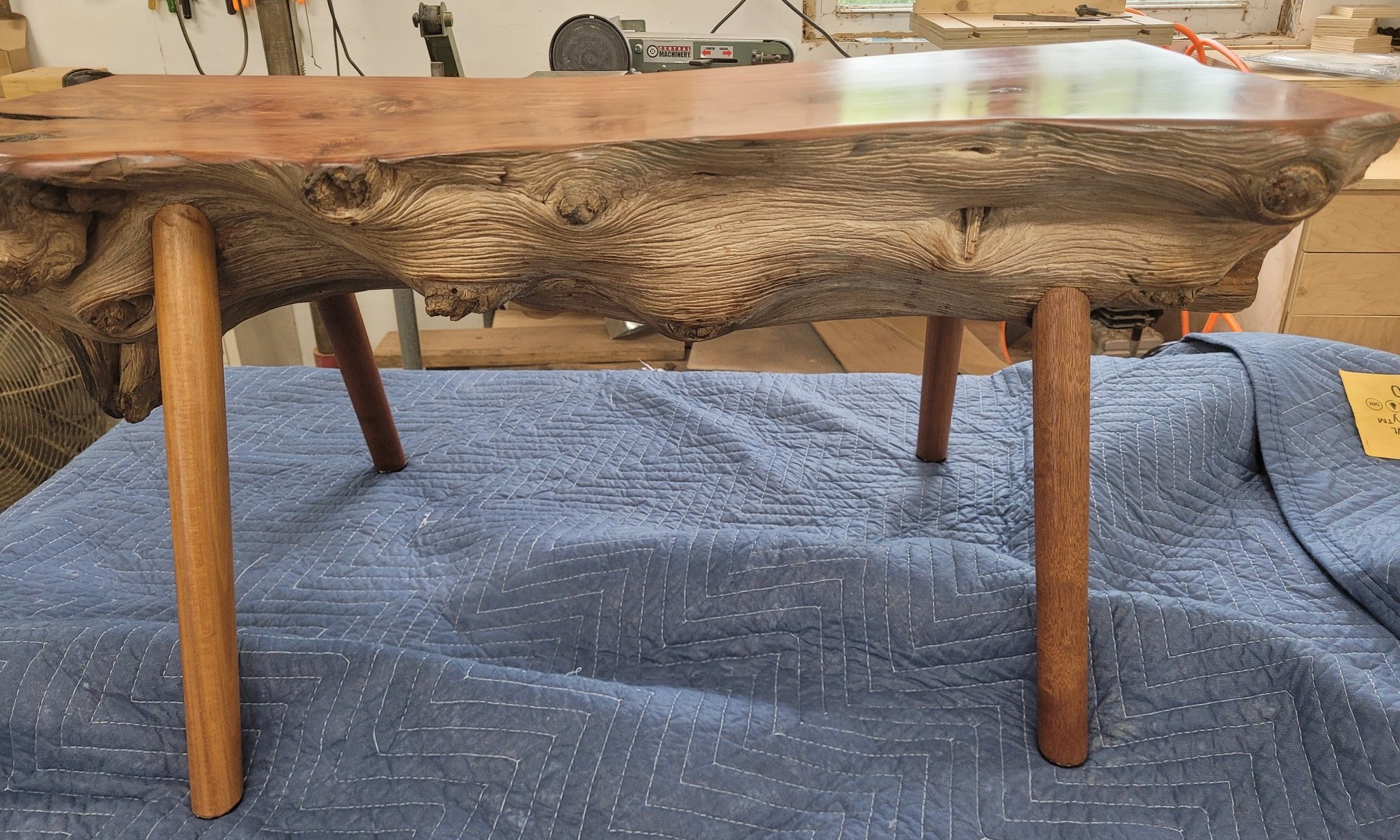Red cedar bench/table with mahogany legs. 
I was tasked with adding legs and finishing this cedar log. 