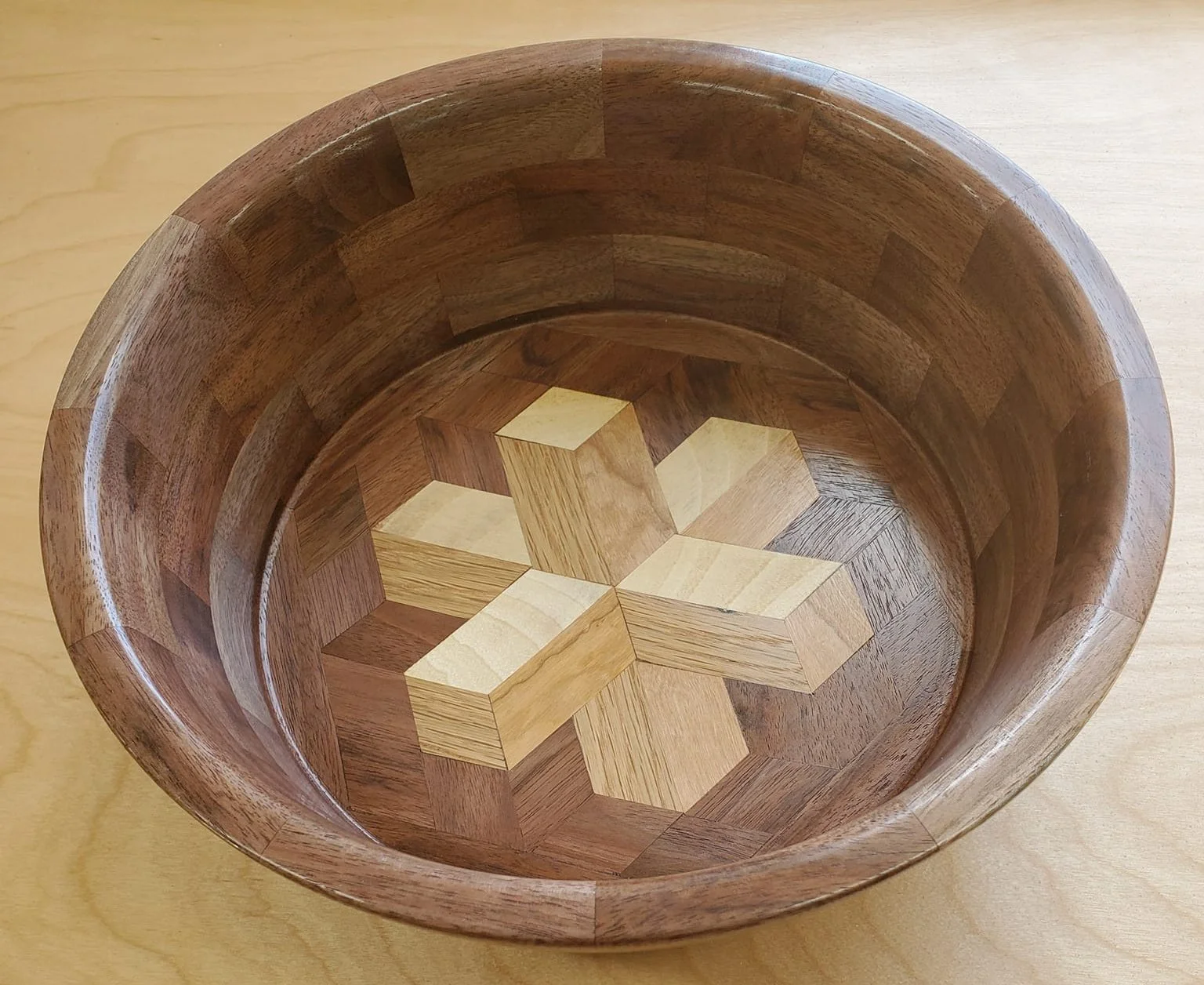 The bowl is made from walnut and the design is maple, cherry, and oak.