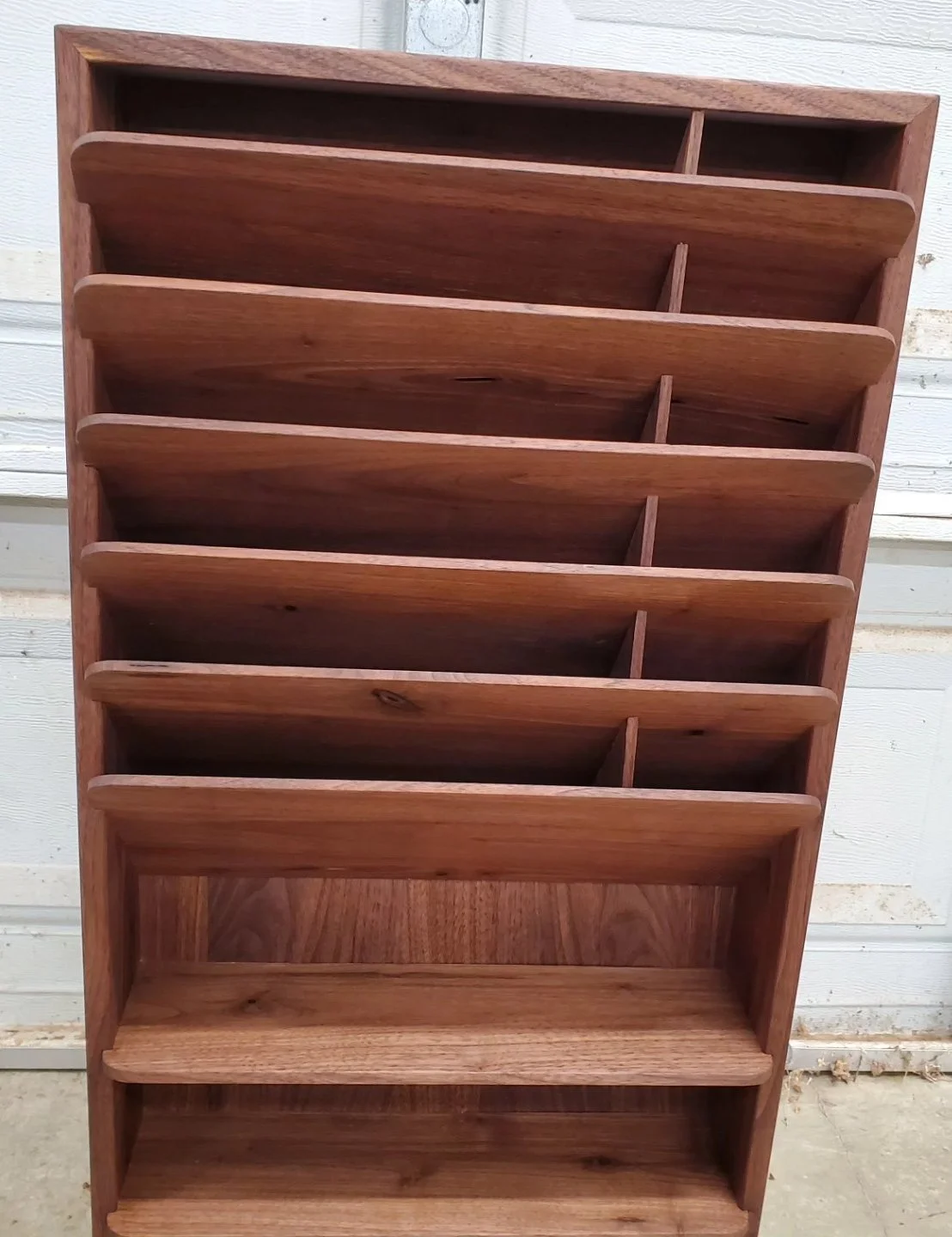 Walnut organizer that's meant to be hung on a wall to help keep your paperwork from cluttering your desk. Maple splines in the corners to add strength and a little contrast.