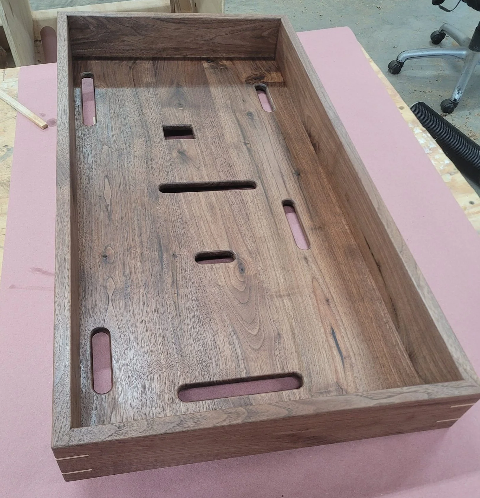 Walnut wall mounted PC case.
Mitered frame with maple splines to reinforce the corners, floating back panel to allow for wood movement and cutouts for various cables.