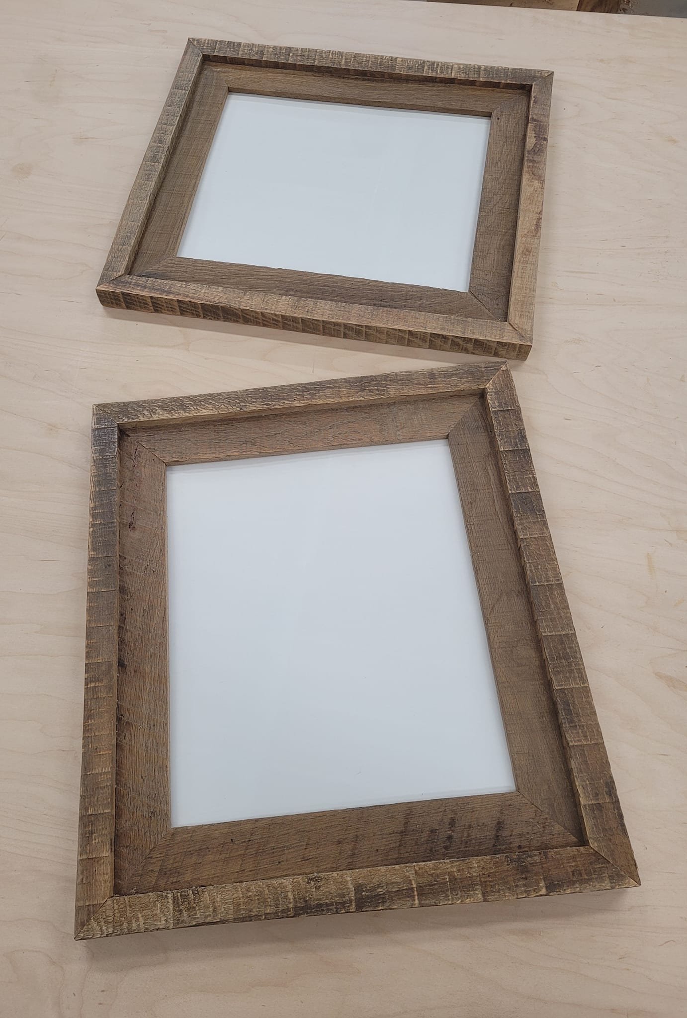Two rustic custom picture frames made out of oak.
