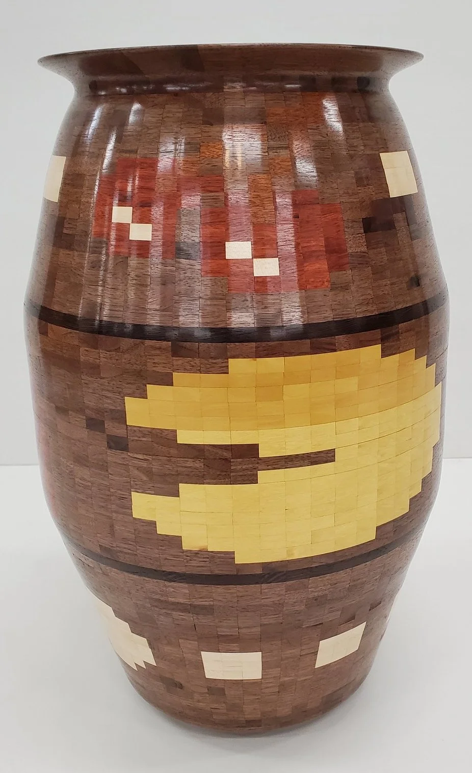 Wakka Wakka
This vase is made up of over 3000 (3054 to be exact) individual pieces of wood! It stands nearly 2' tall and 14.5" around at the widest.

Walnut, maple, bloodwood, osage orange, yellow heart, purple heart, wenge, black limba, and mahogany