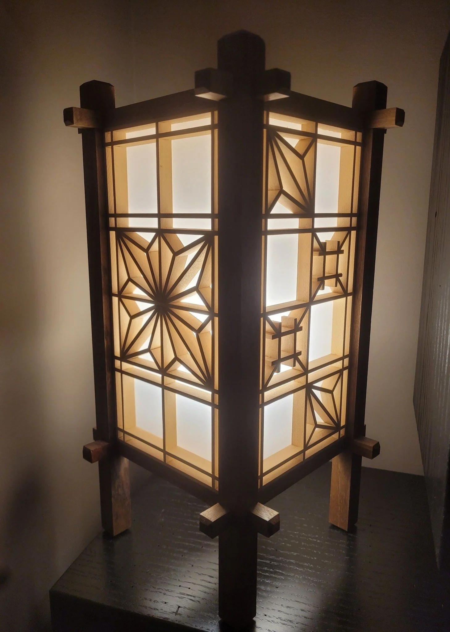 I was playing around with a Japanese technique called Kumiko and made these lamps out of the panels. The Kumiko panels are made of strips of poplar, and frame is walnut. Each side of the lamp is different.