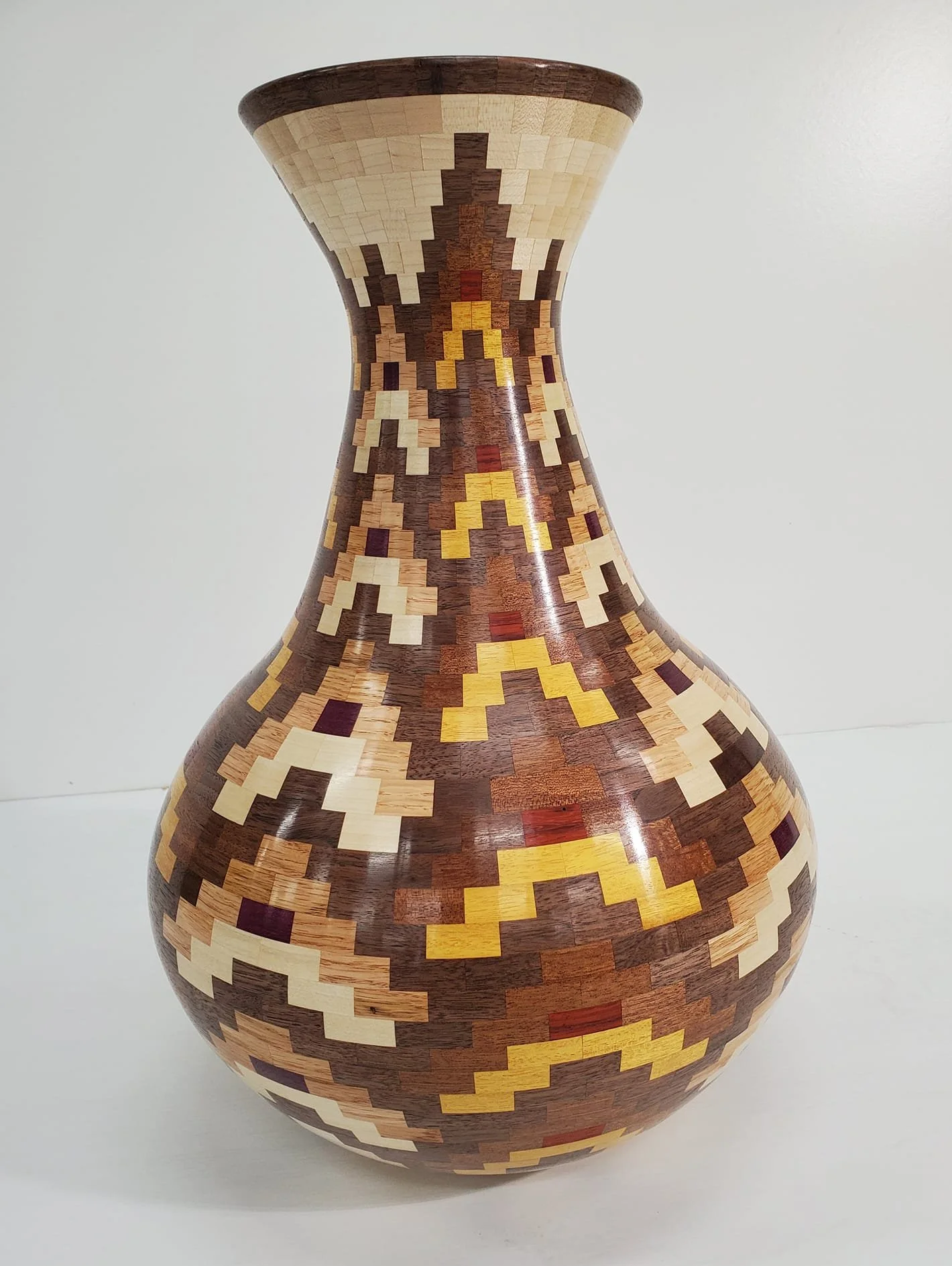 'Elevate'. 
30+ hours, over 1500 piece (1,549 to be exact) and 9 different species of wood! Nearly 20" tall. Maple, poplar, padauk, walnut, red oak, purple heart, osage orange and sapele.

Click the picture for a video link of the vase coming togethe