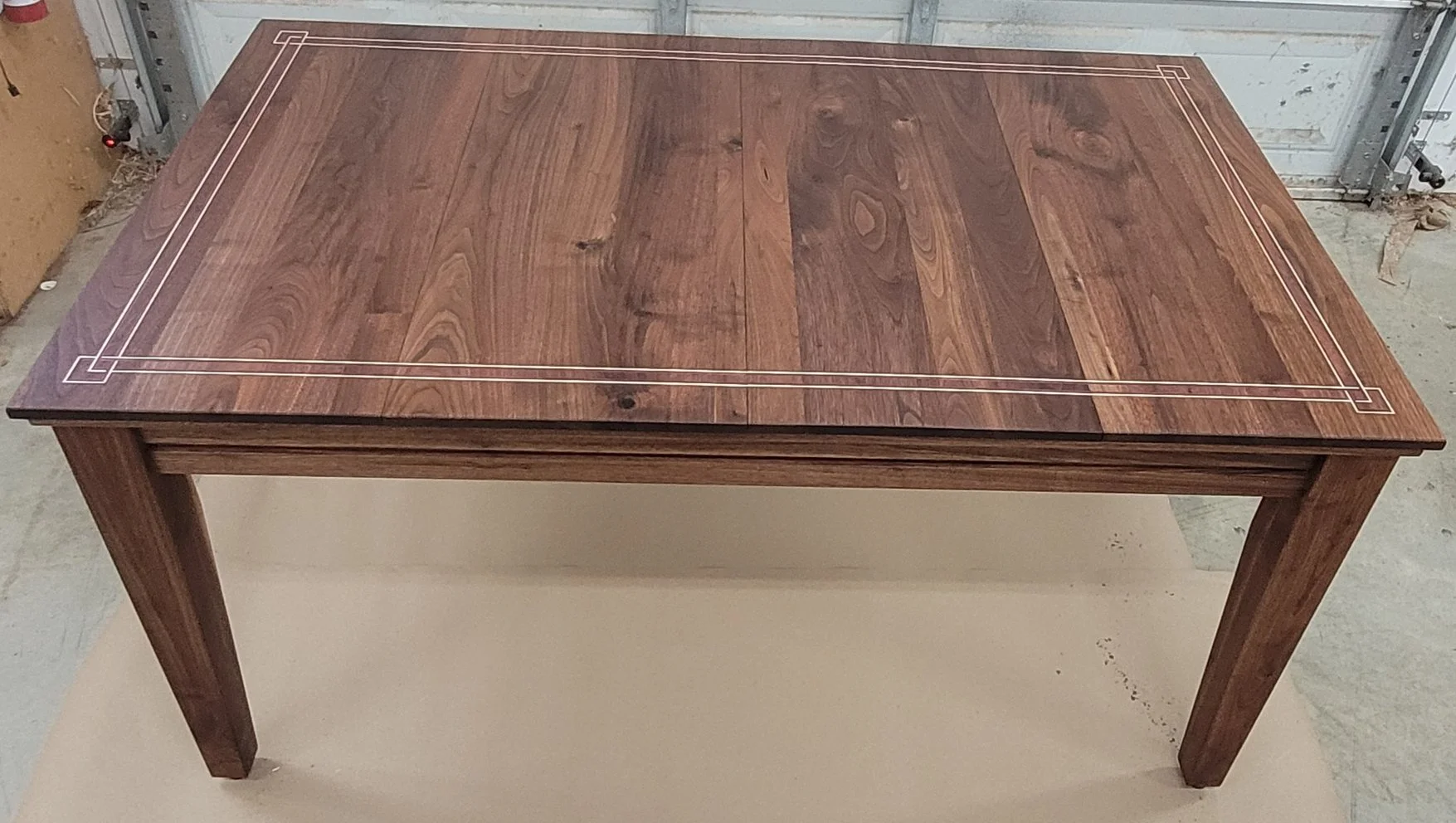 This whole table is solid walnut The string inlay is made of purpleheart, wenge and maple, and the suits inlay on the gaming rail are bloodwood and Indian ebony. I also added some LED lights to it. Finished with a hardwax oil and a topped with a cera