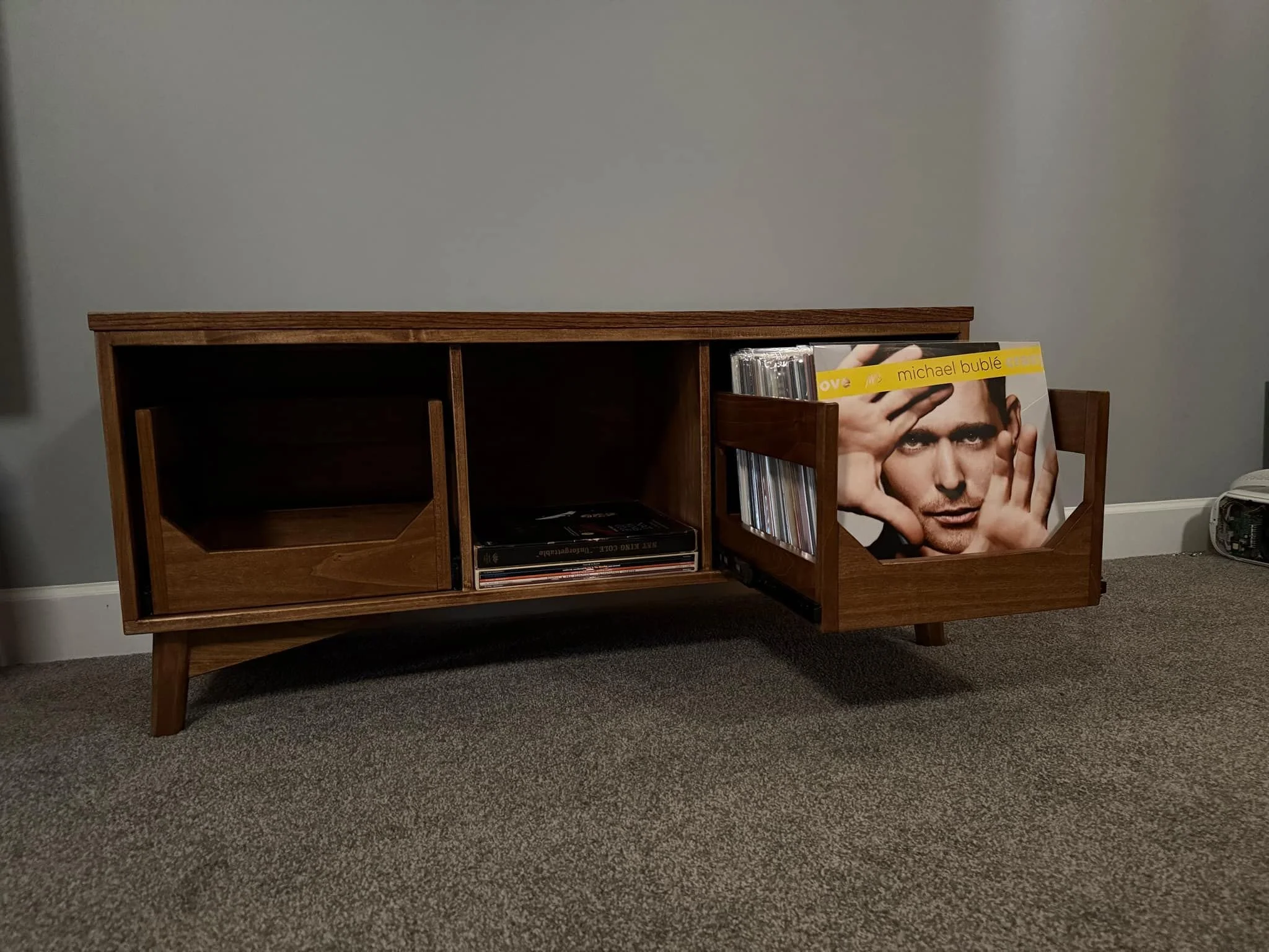 Record cabinet perfect for storing and displaying your vinyl collection. The cabinet is made of poplar and the top is oak with a plywood back panel. The color is a mixture of a couple different stains to match an existing piece of furniture. 