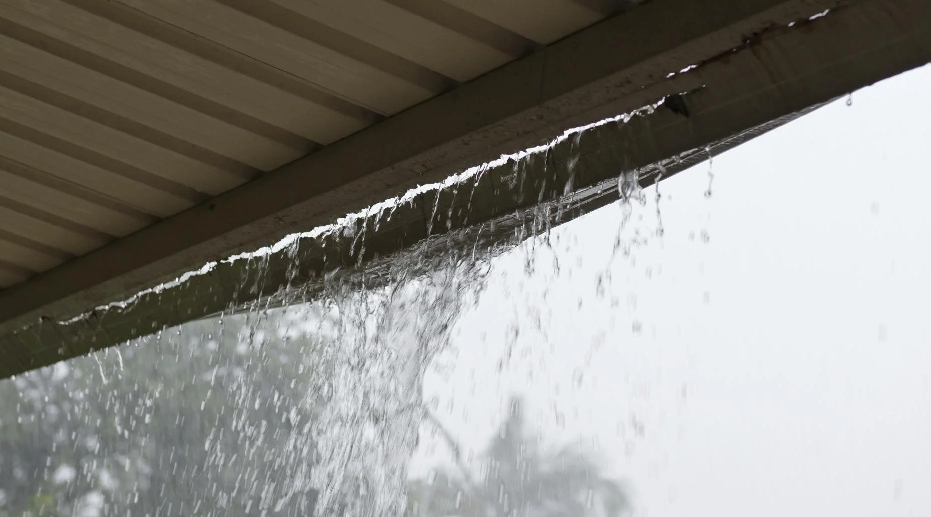 Why Water Drips Behind Your Gutter Instead of Into It