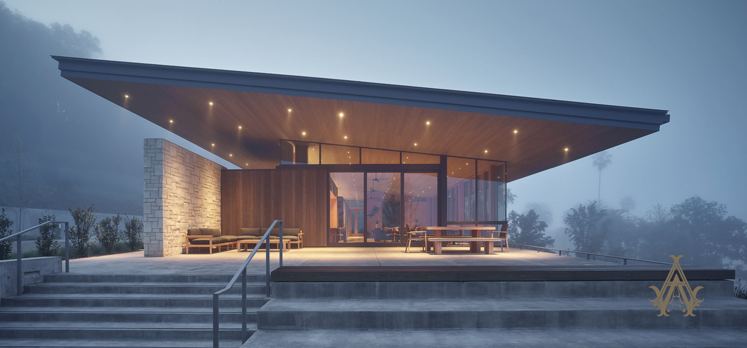Modern house with large overhanging roof, glass walls, outdoor seating, surrounded by foggy landscape with trees.