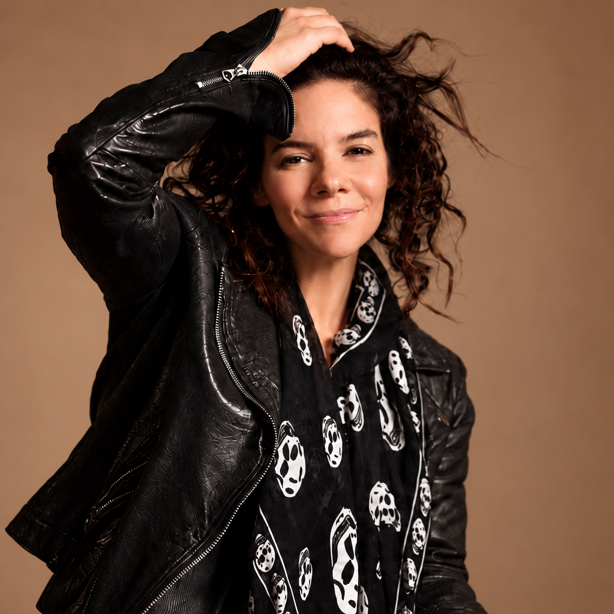 Jess Rothschild in a leather jacket and patterned scarf