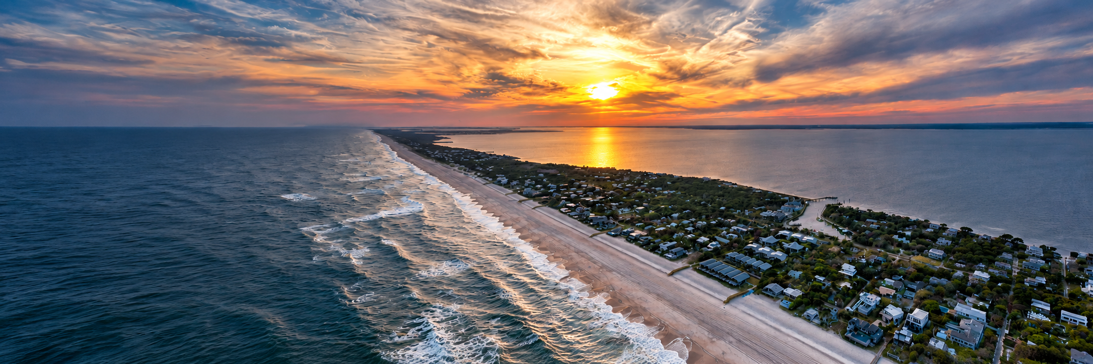 Aerial view of Fire Island coastline and Pines homes at sunset