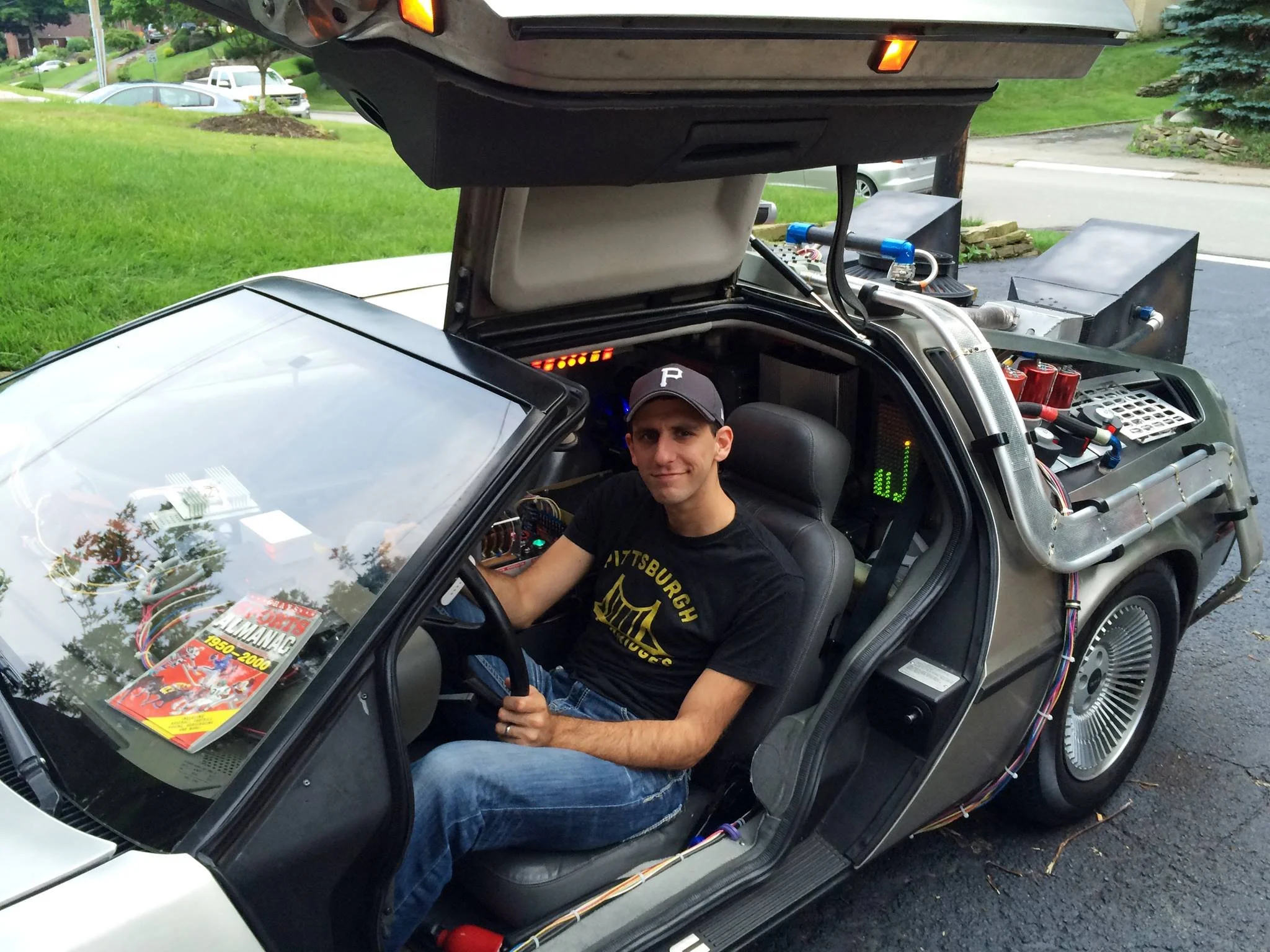 Director Chris Preksta seated inside the Delorean time machine from Back to the Future.