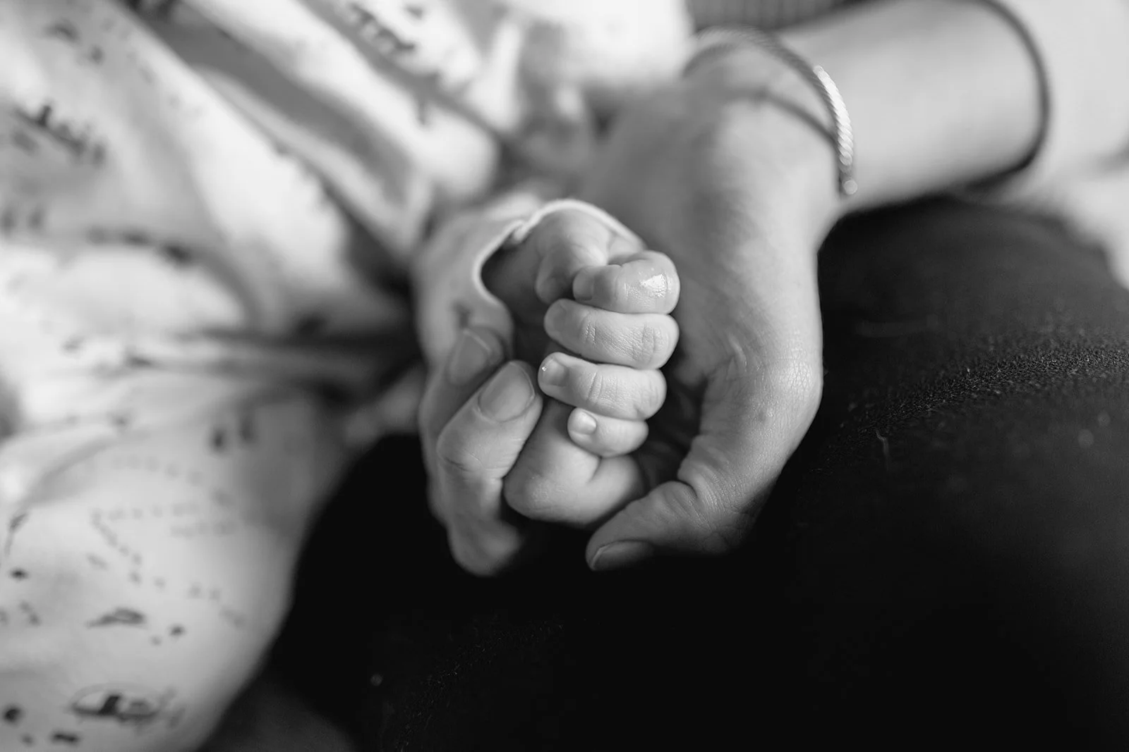 mom and baby holding hands