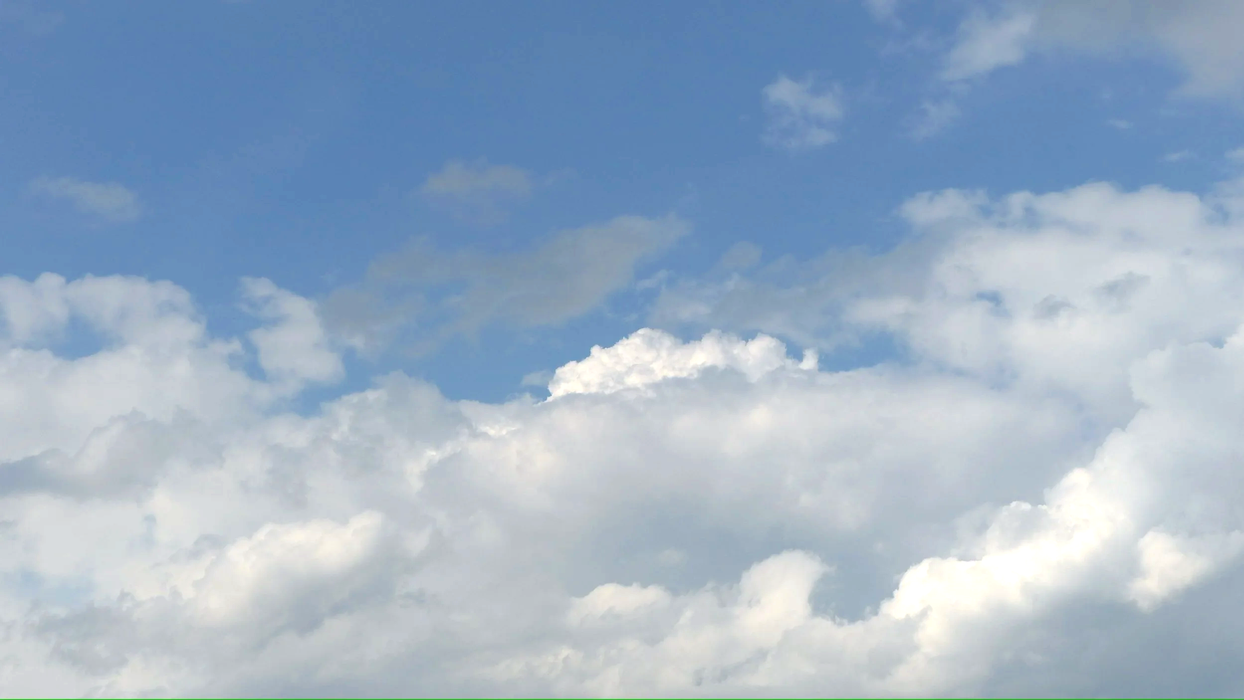 Blue sky with white fluffy clouds.