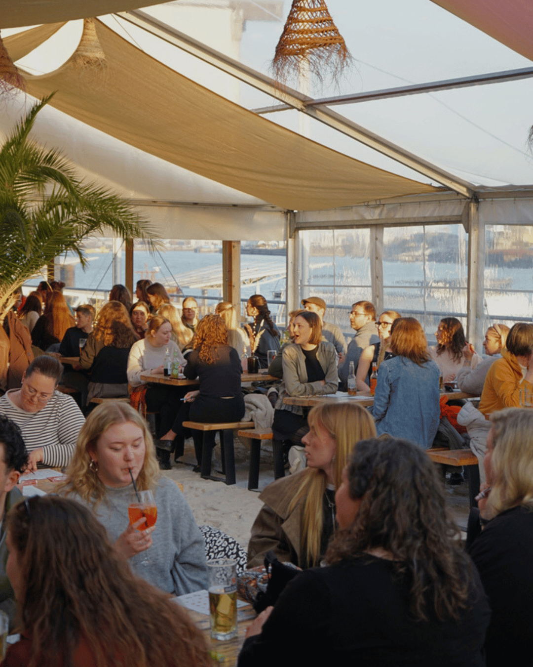 Music Bingo Hamburg at Sonnendeck featuring multiple tables of players marking bingo or holding drinks.