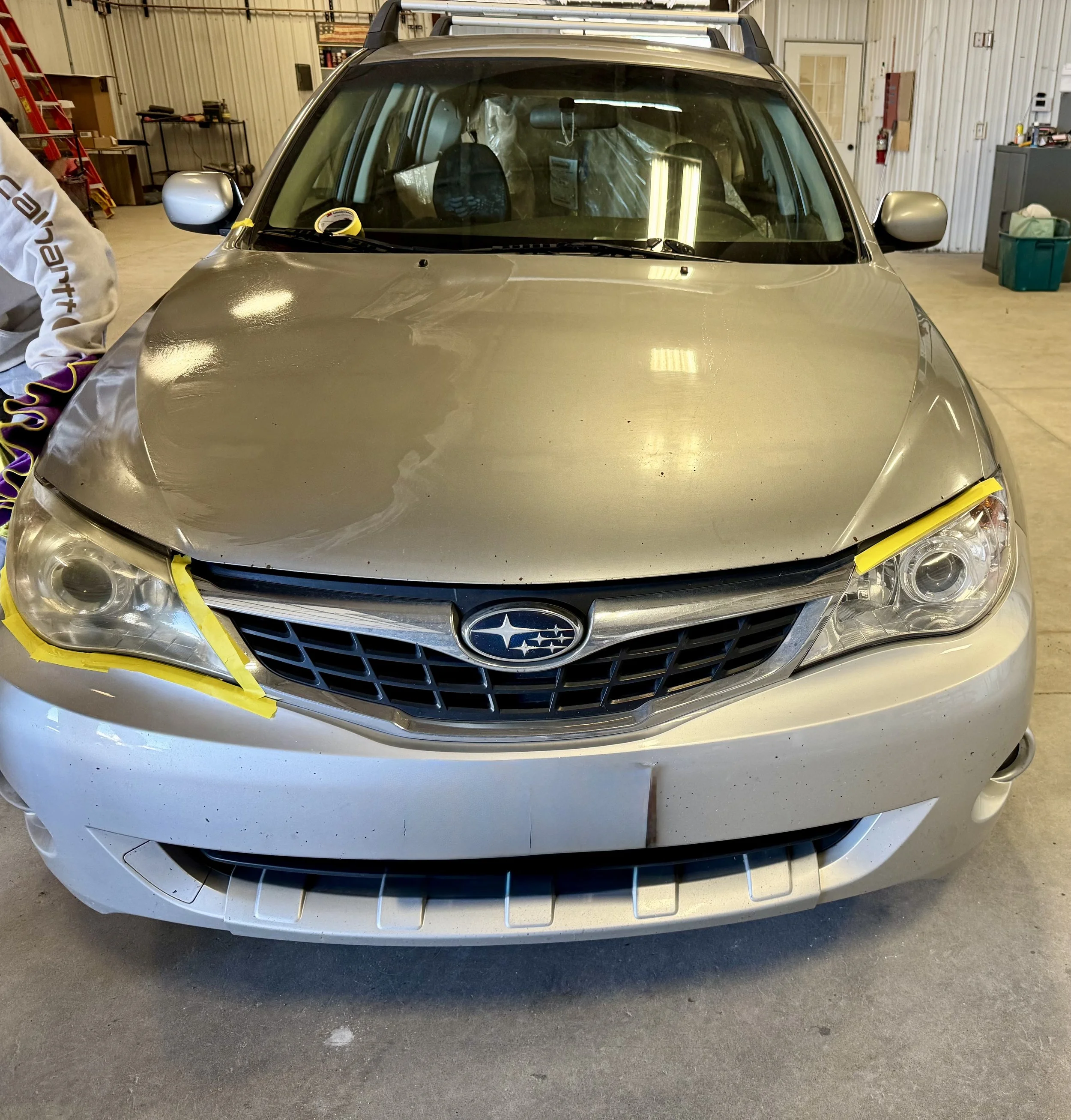 Silver car with rock damage on the hood