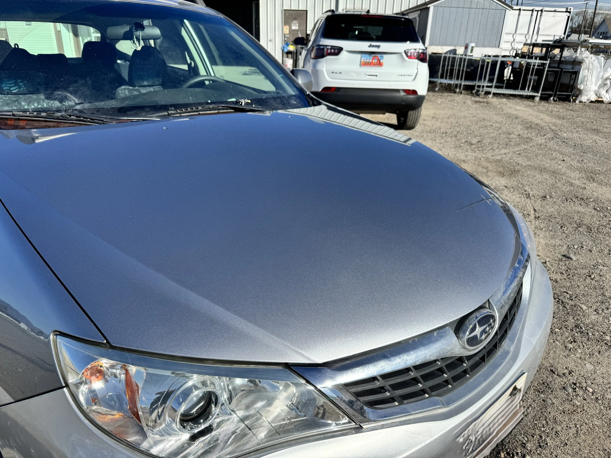 silver car with the rock damage repaired and refinished.