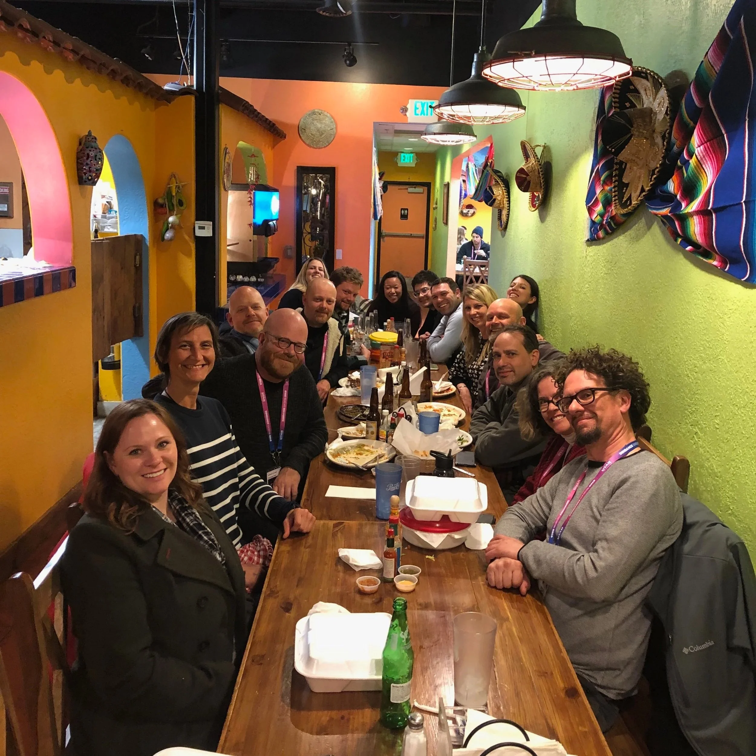 A long table filled with a happy team.