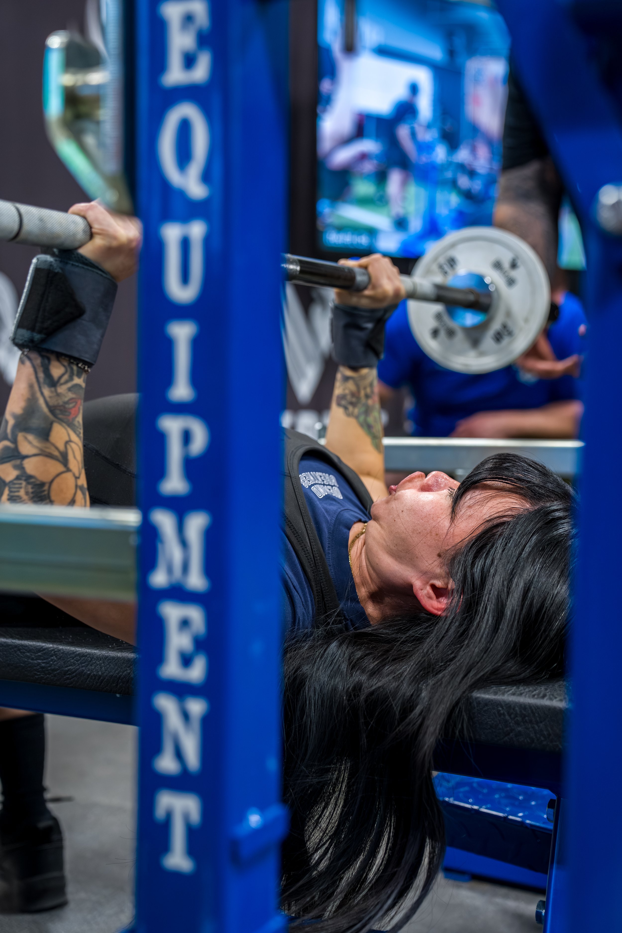 Uplift Grant recipient is finishing her bench press attempt at a USPA competition.