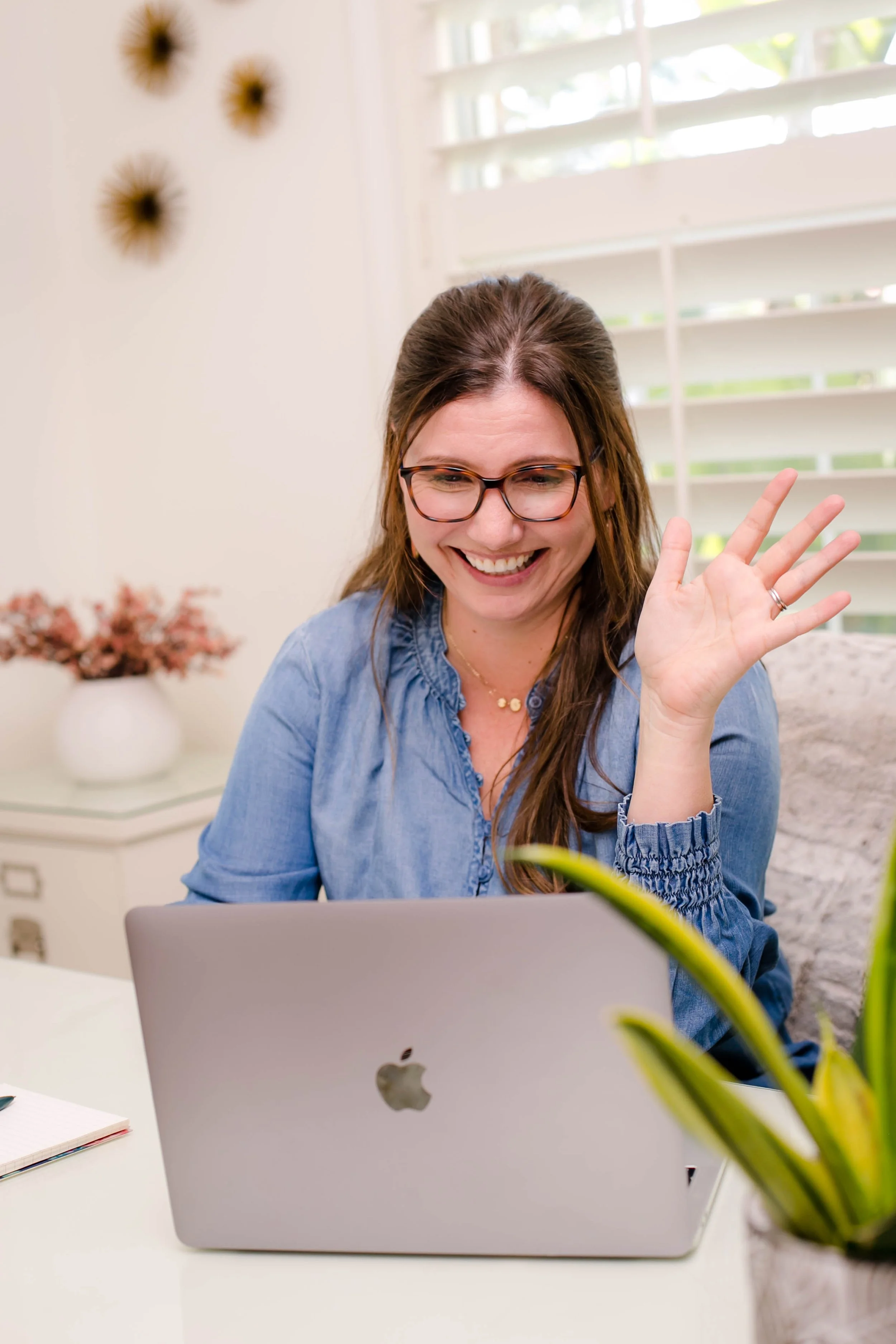 Dr. Katrina stone waving to a patient during a telehealth session