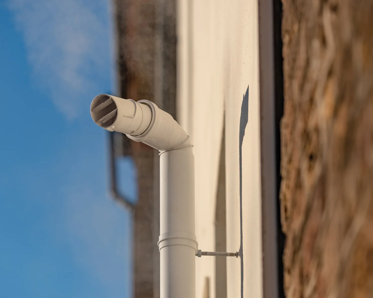 PVC exhaust vent pipe for high-efficiency condensing boiler installed by AeroDrop in the Hudson Valley NY