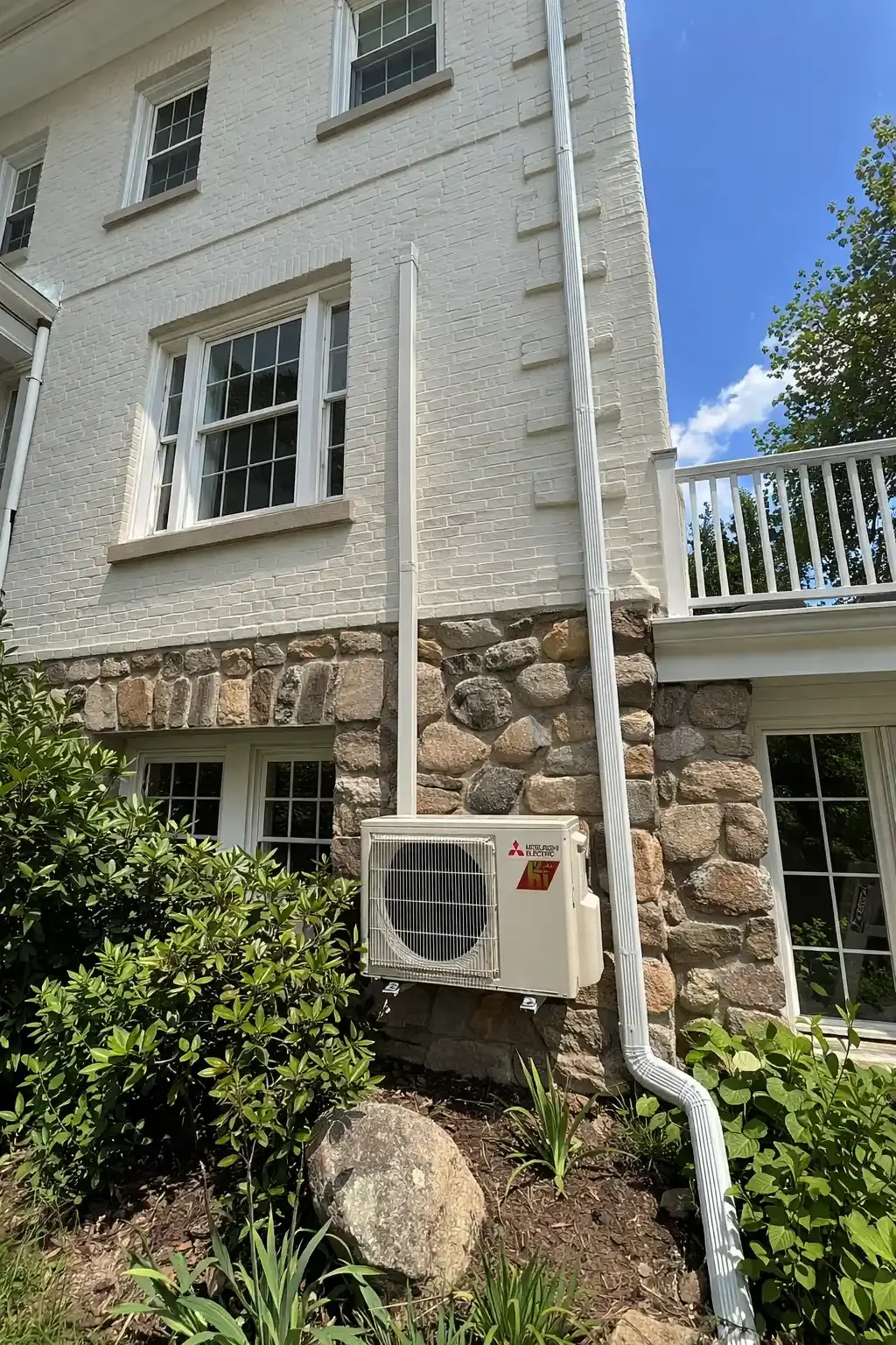 Mitsubishi Electric mini-split condenser installed on a historic brick home in the Hudson Valley by AeroDrop