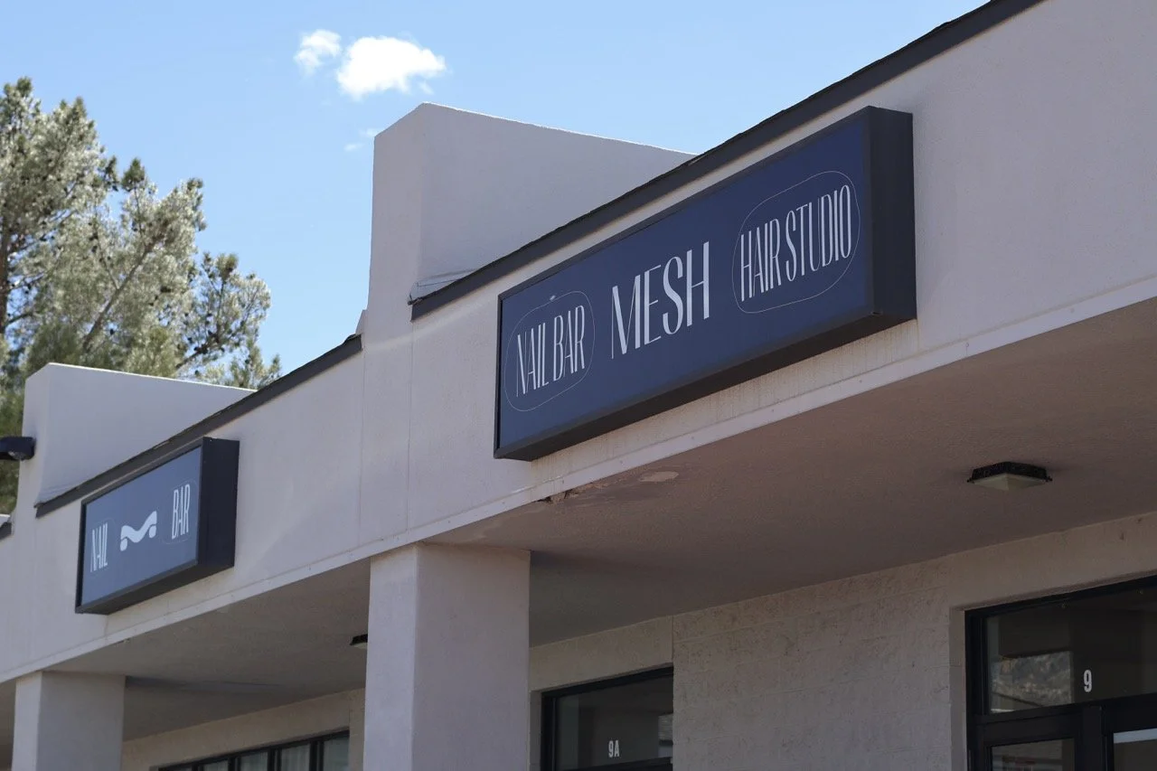 Sign for Nail Bar, Mesh, and Hair Studio on the exterior of a building.