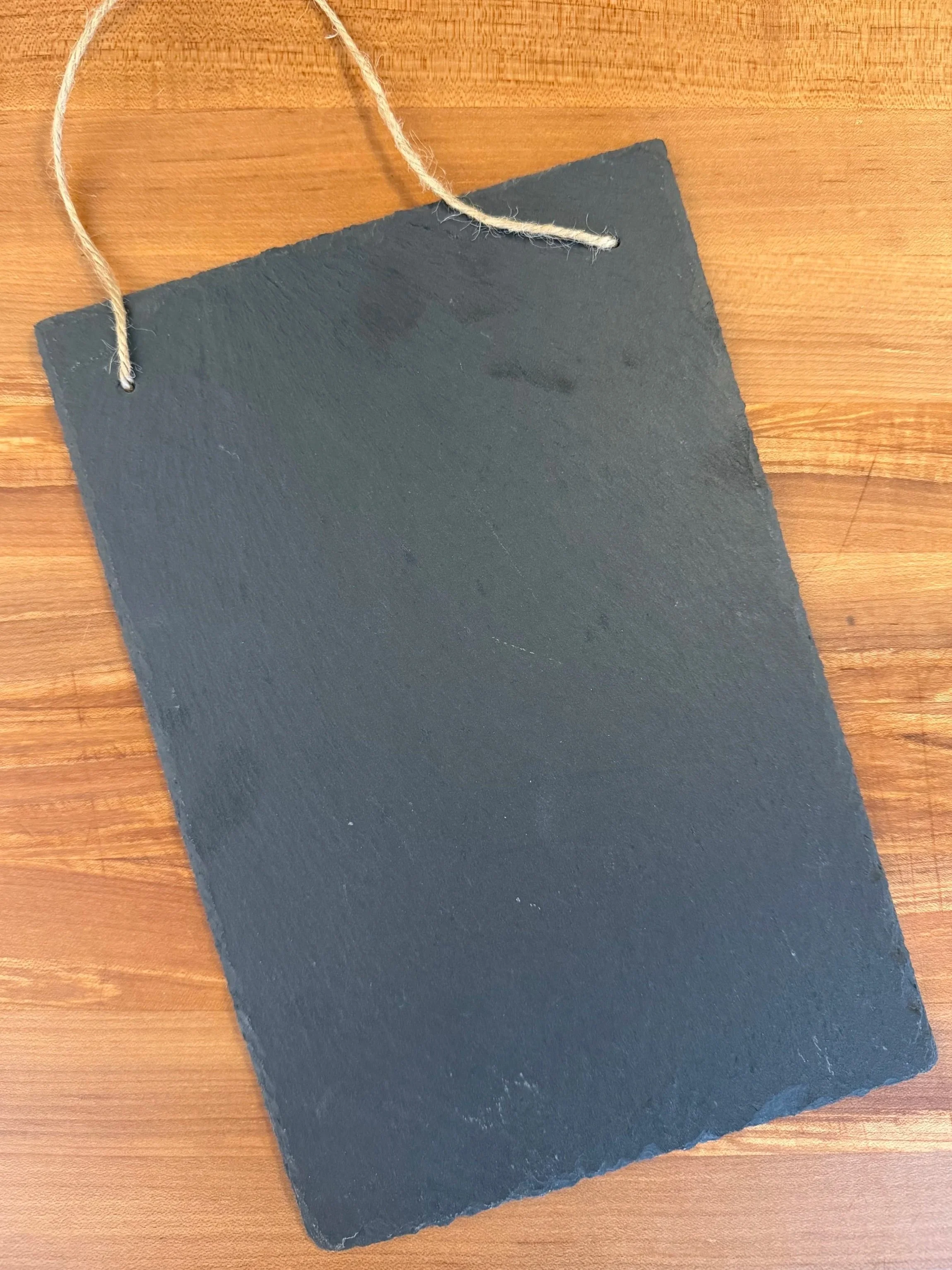 $50  -  8" x 11" Slate Sign:

Portrait-oriented with rope hanger. Able to be engraved on front and rear surfaces.