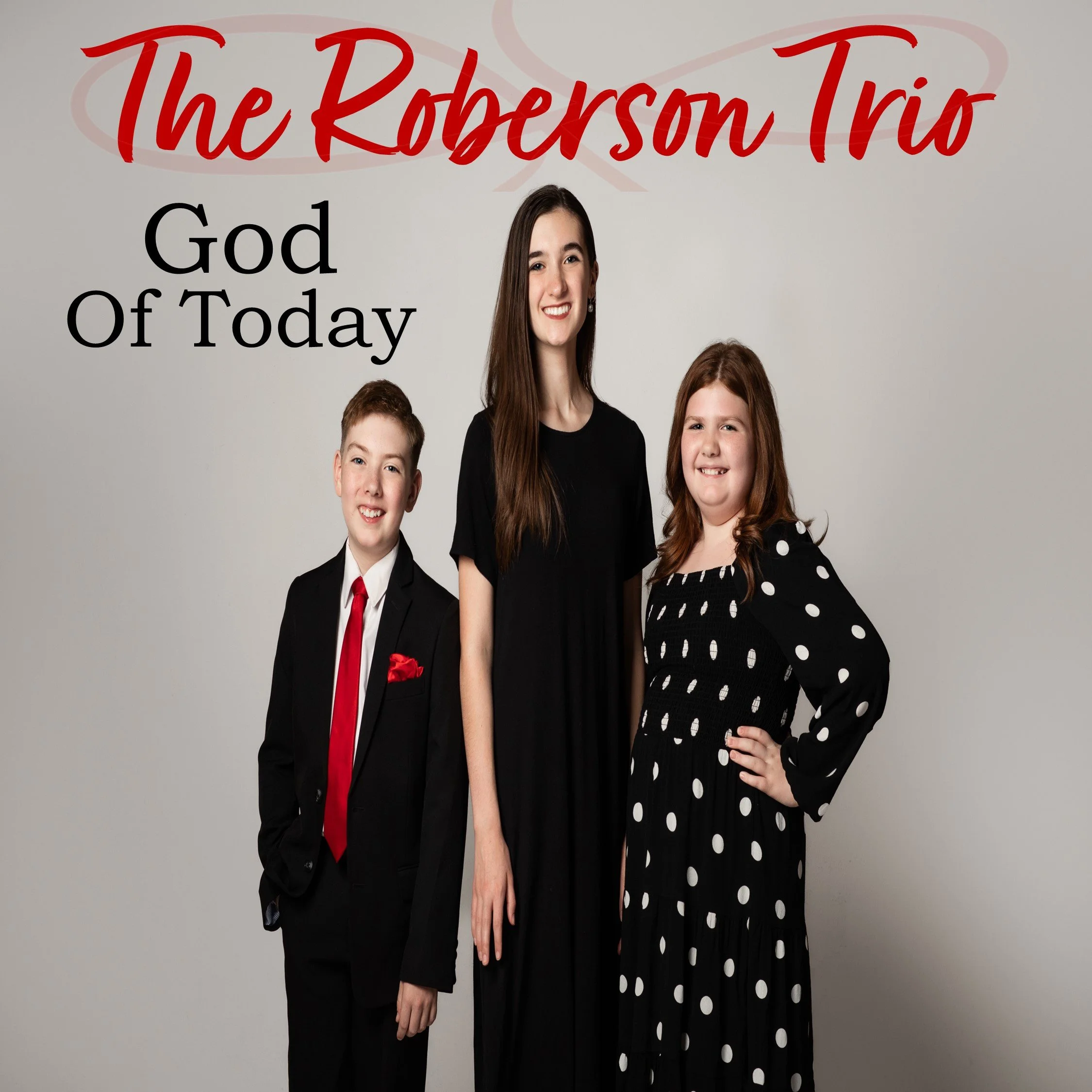 A family portrait of three young people dressed in formal attire, standing against a plain white background. The oldest girl in the center is wearing a black dress, the boy on the left is in a black suit with a white shirt and red tie, and the younger girl on the right is in a black dress with white polka dots. There is red and black text at the top and left side of the image reading "The Roberson Trio" and "God Of Today."