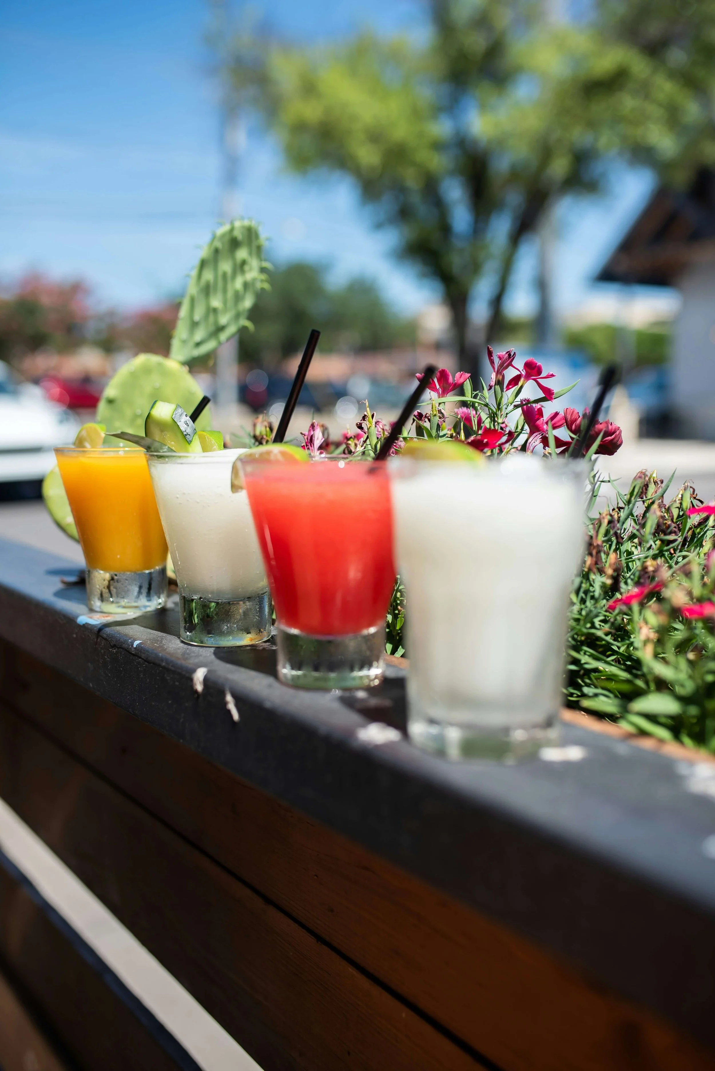 Four margaritas on a patio at restaurant