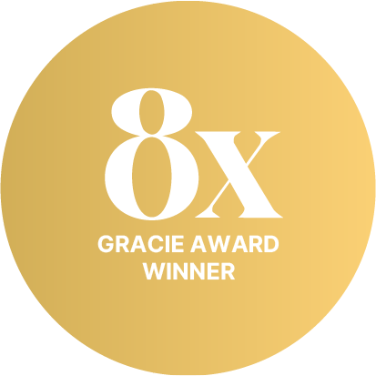 Gold circular badge with white text reading '8x Gracie Award Winner'.
